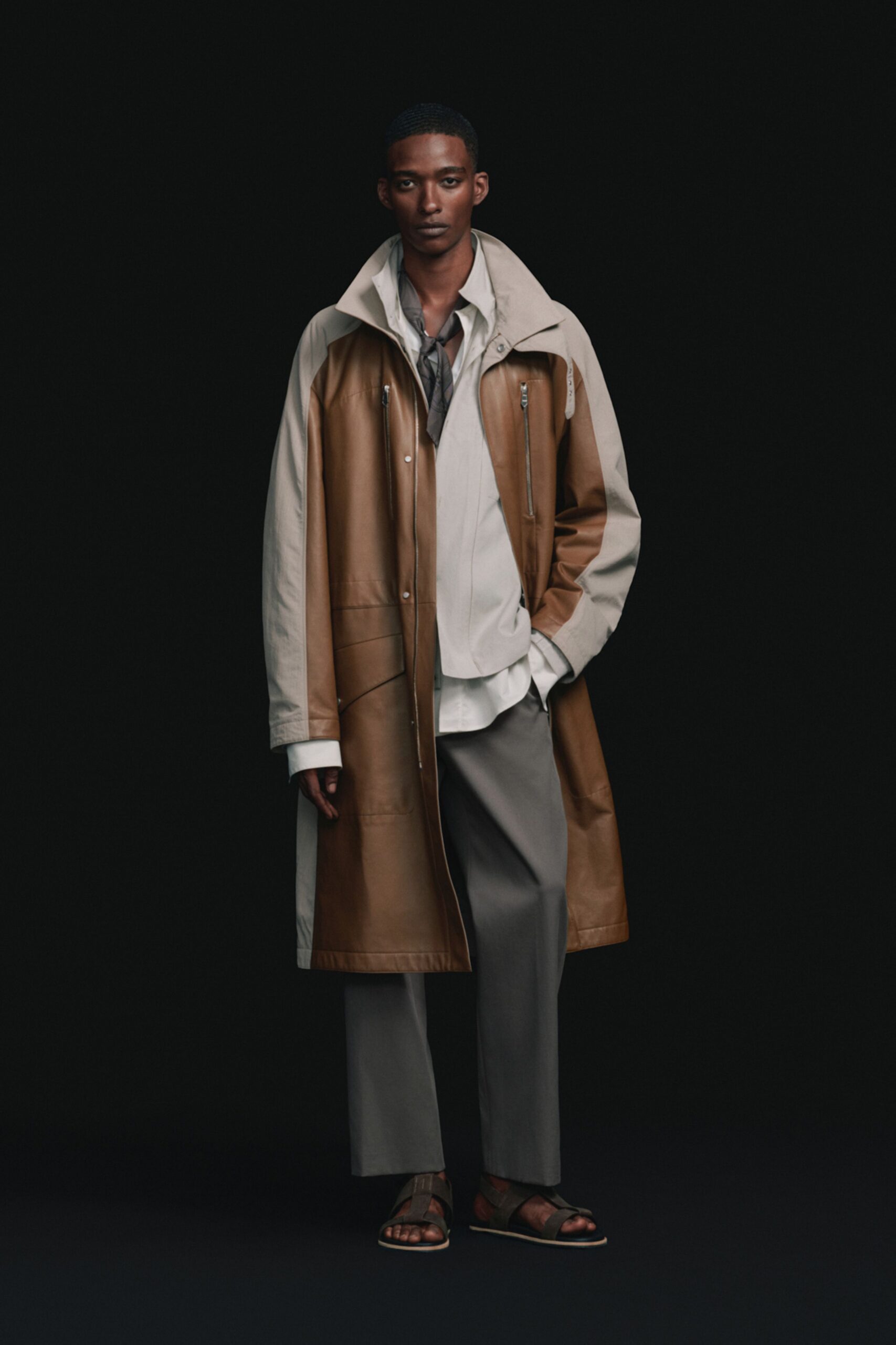 brown leather coat with gray pants