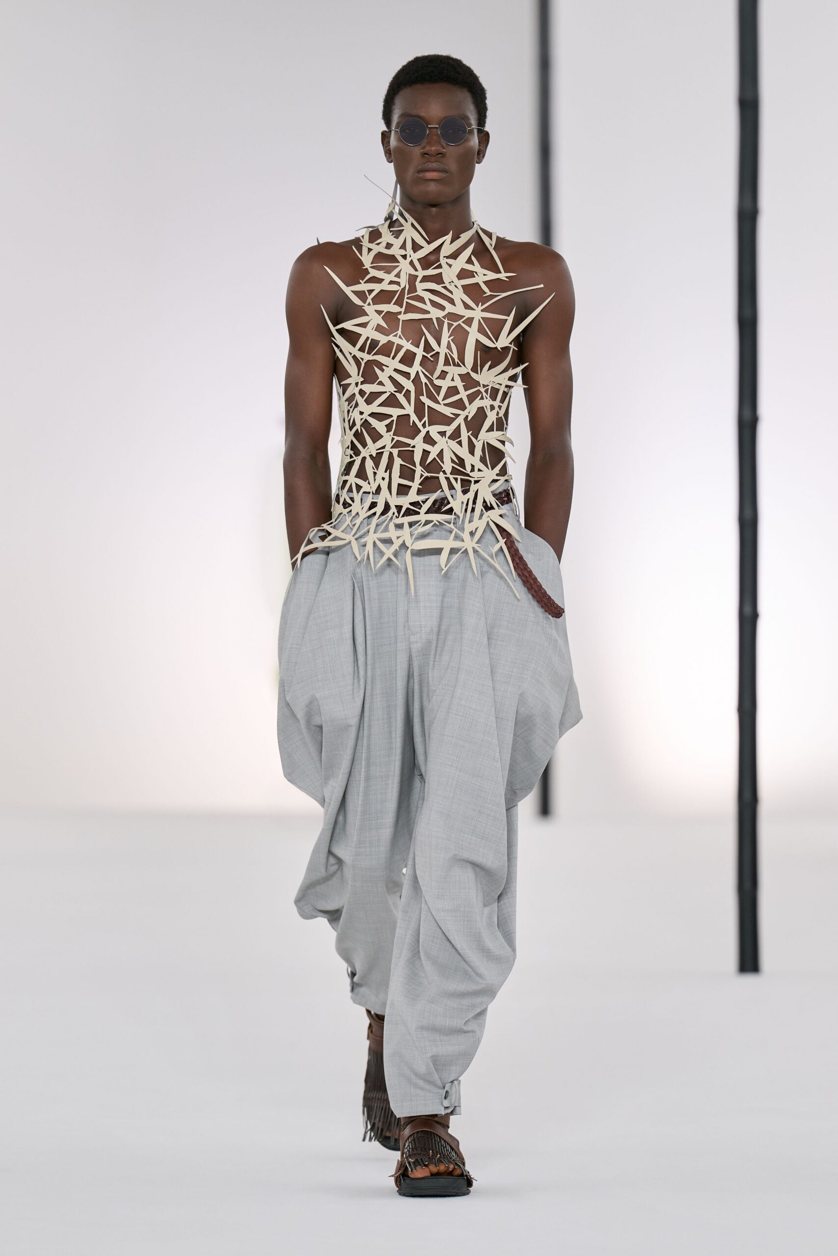 beige embellished sleeveless top with gray relaxed pants