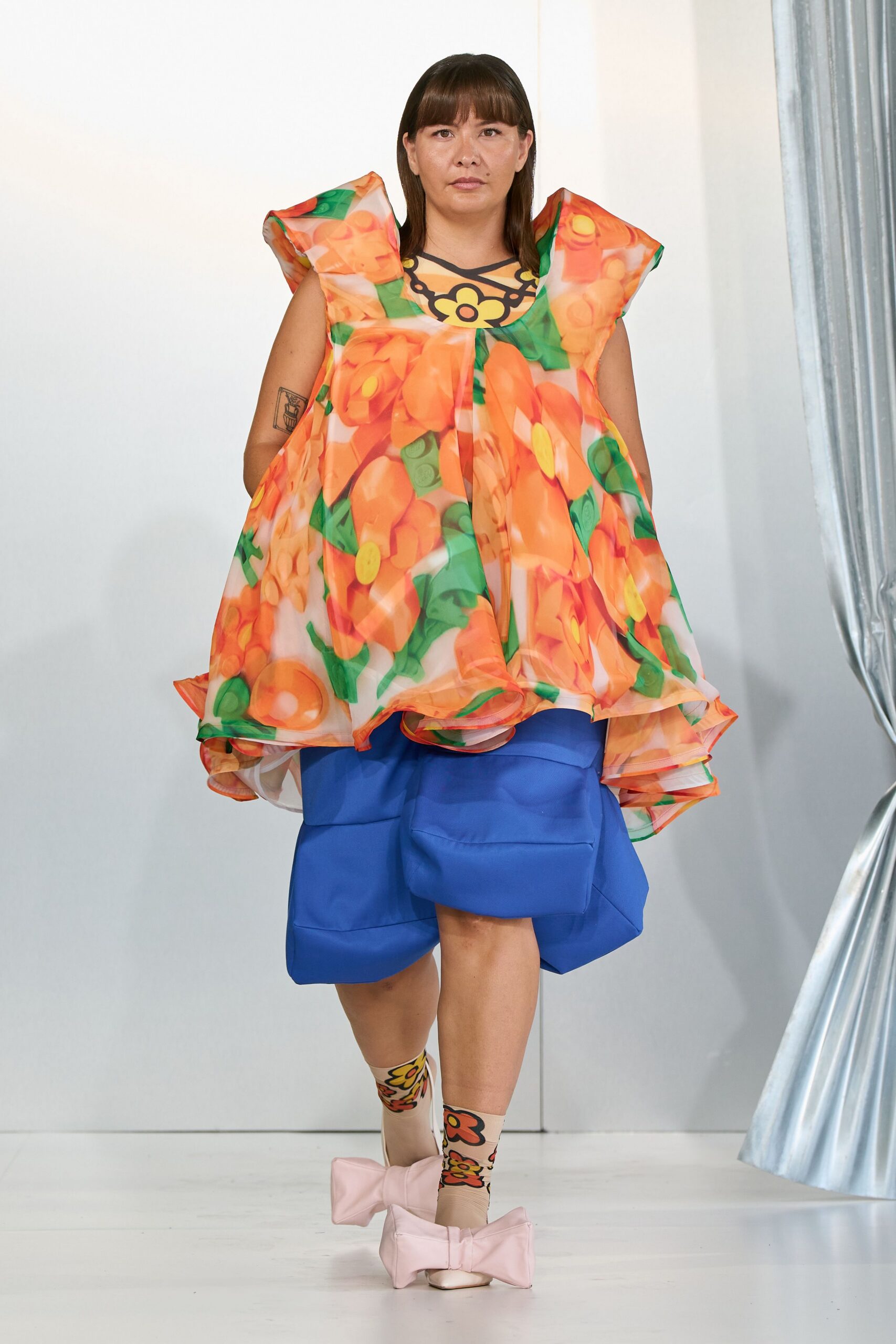 oversized floral top with blue shorts