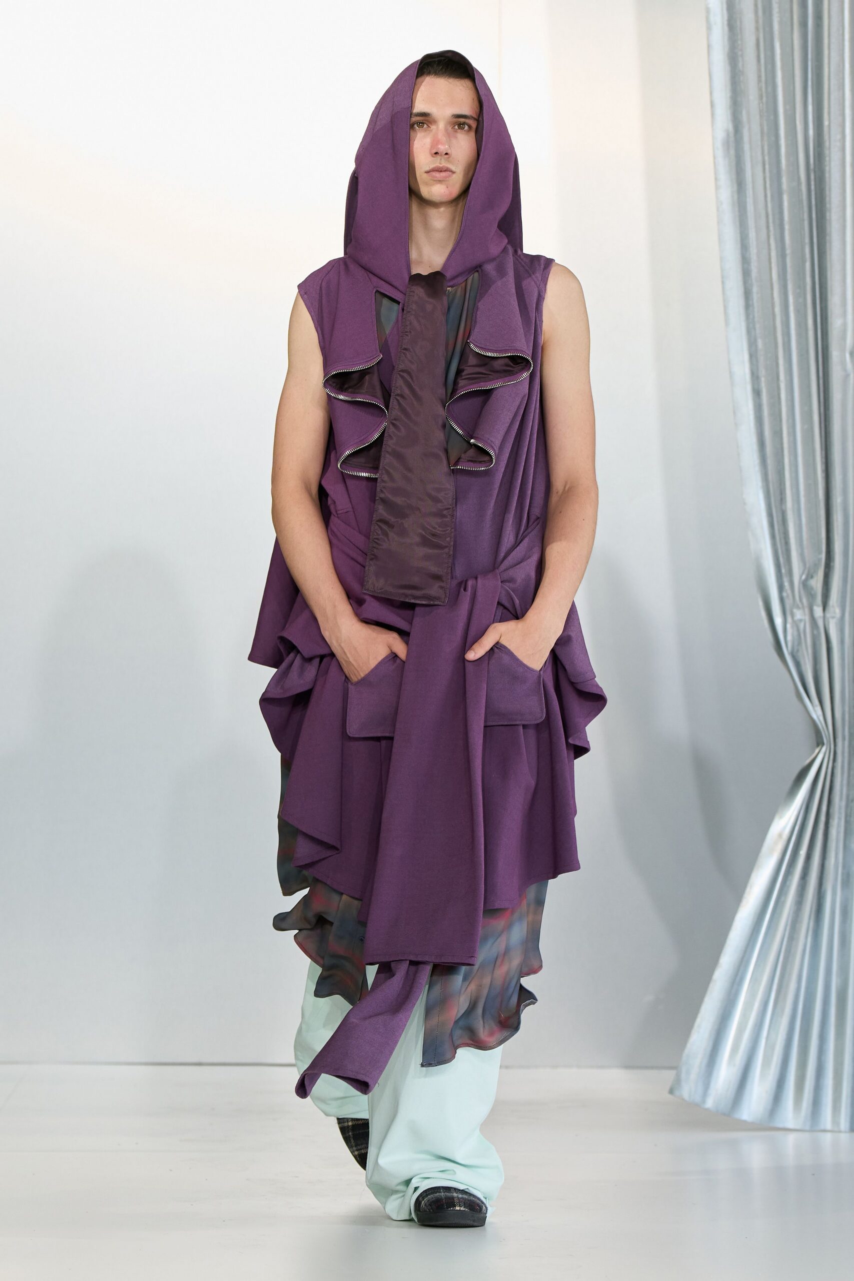 purple sleeveless jacket with light blue pants