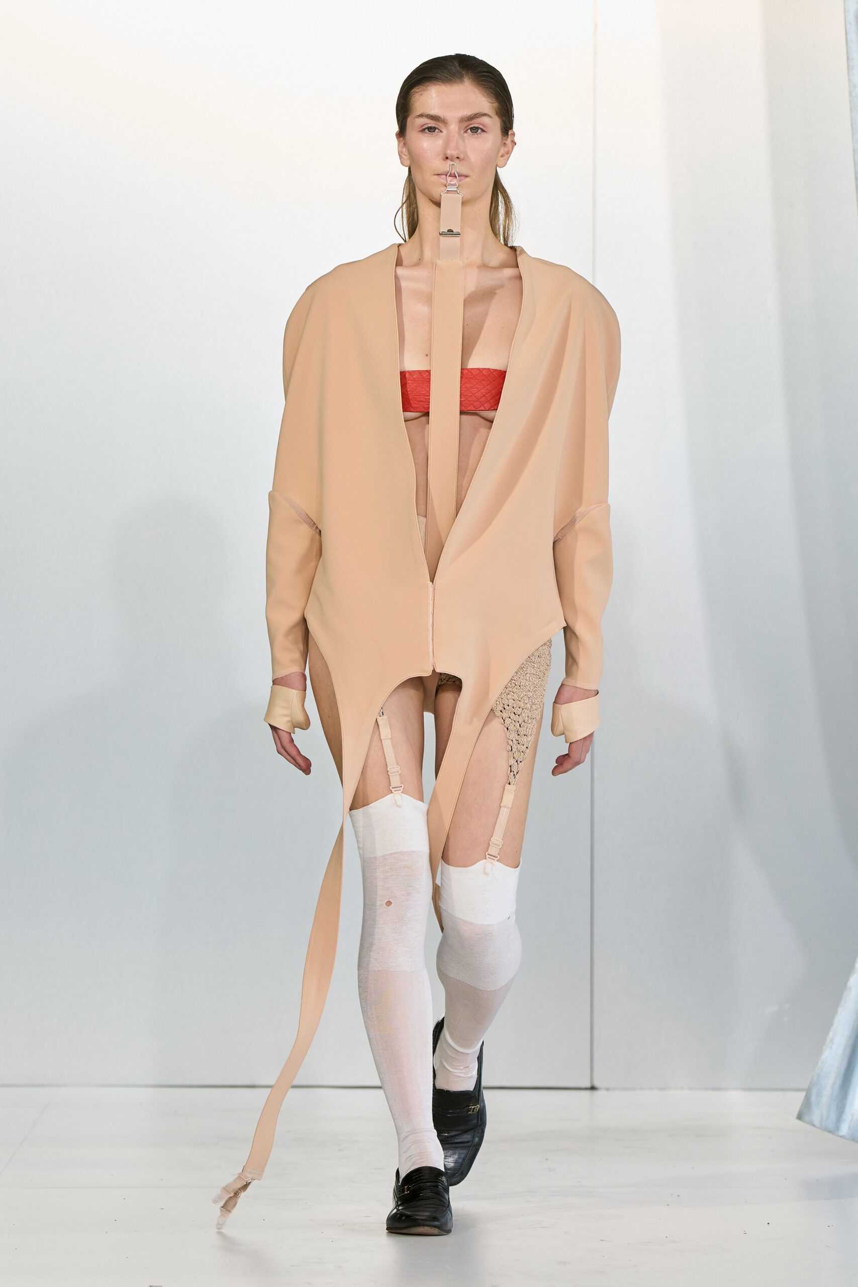 beige neoprene coat with red bra