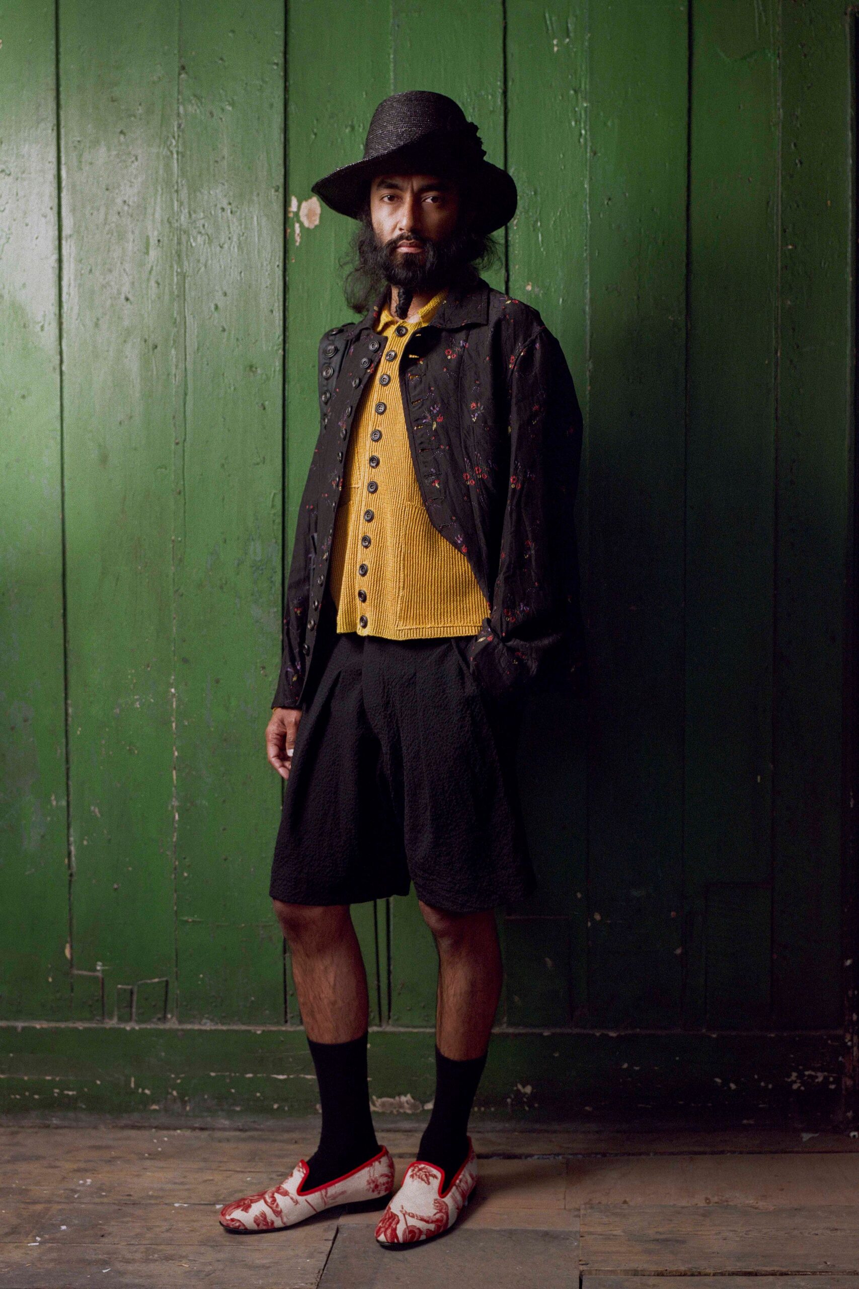 black jacket yellow top black shorts