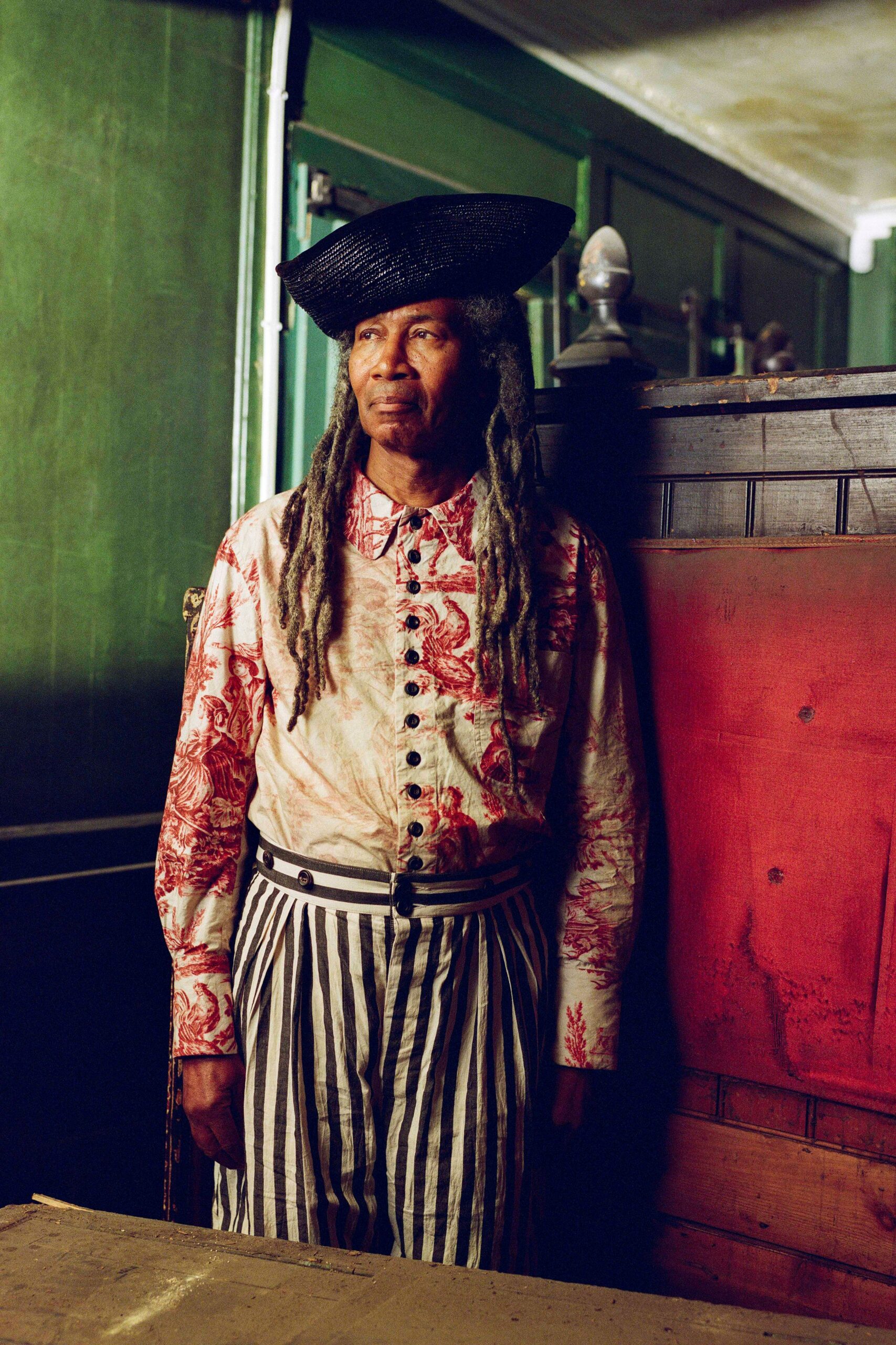 printed shirt striped pants hat