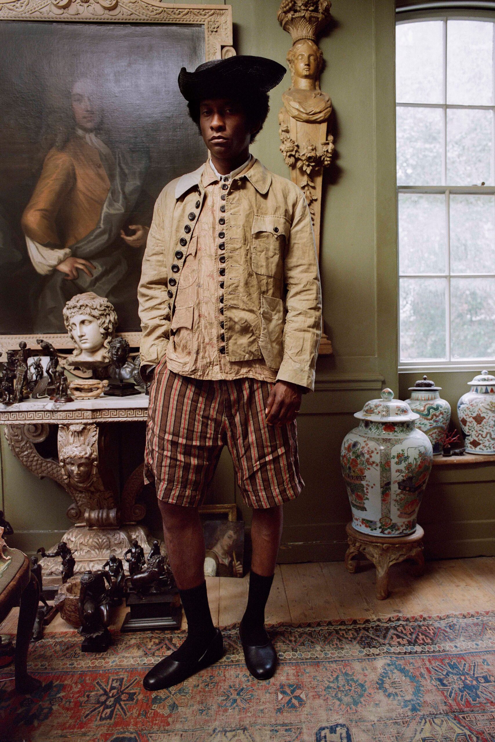 beige jacket pink shirt brown shorts