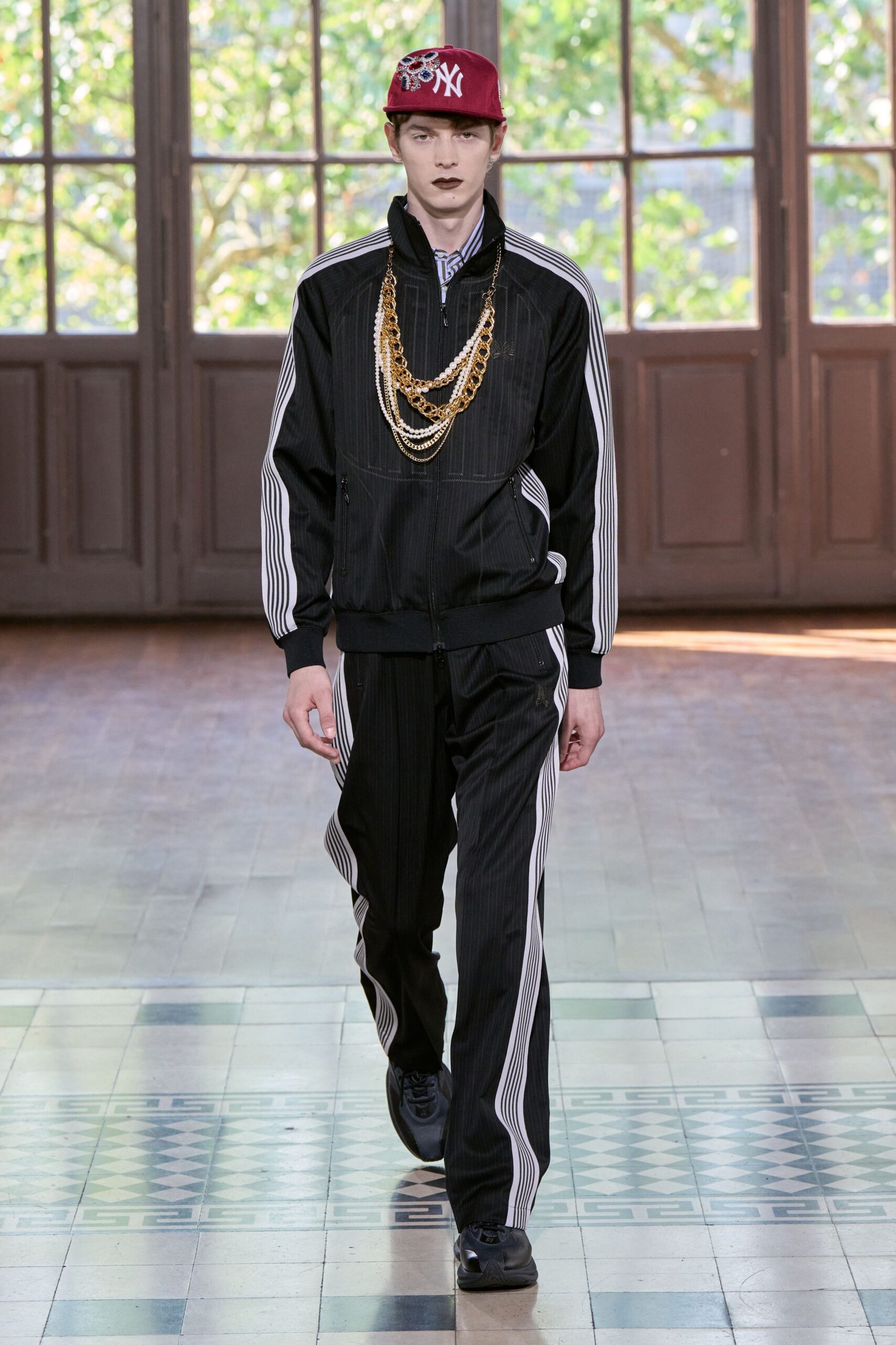 black fitted jacket with gold necklace
