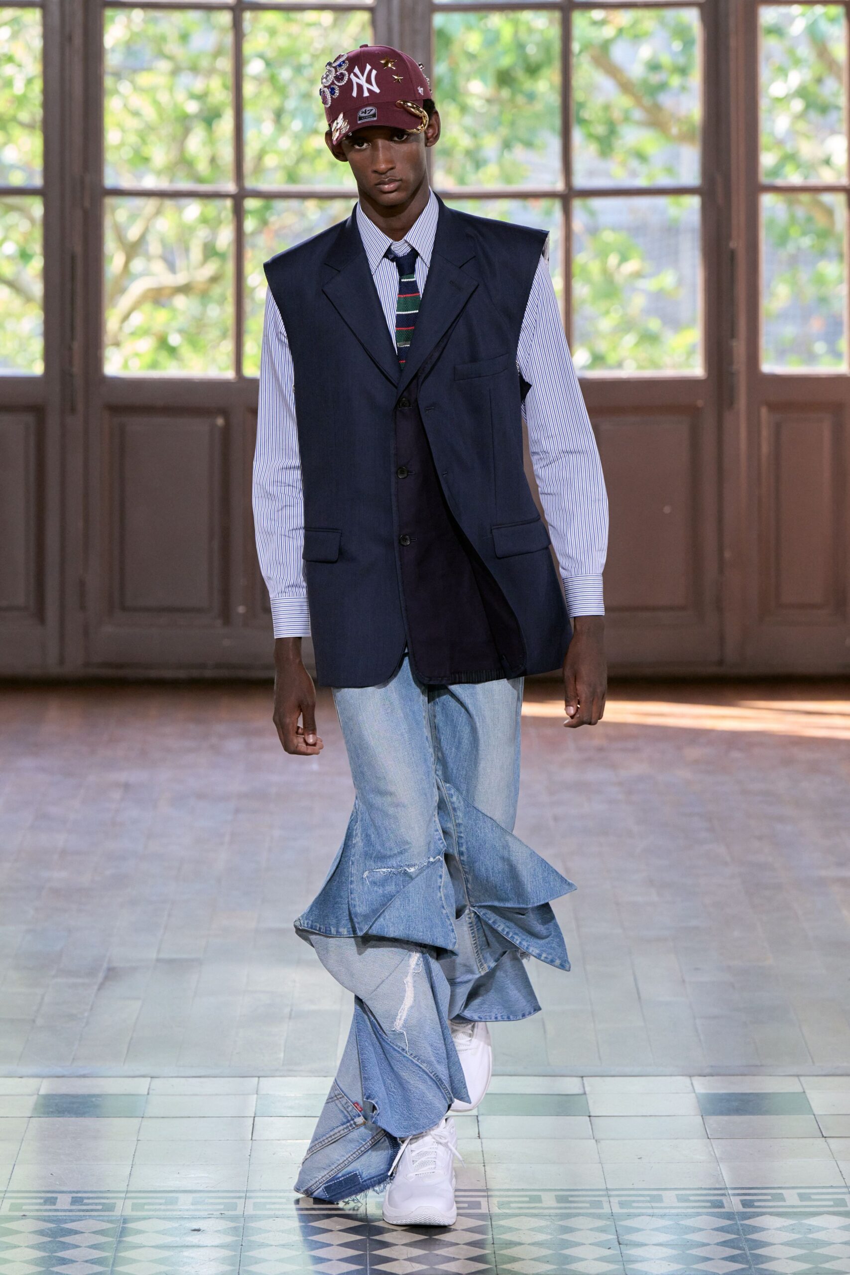 navy tailored vest with flared denim pants