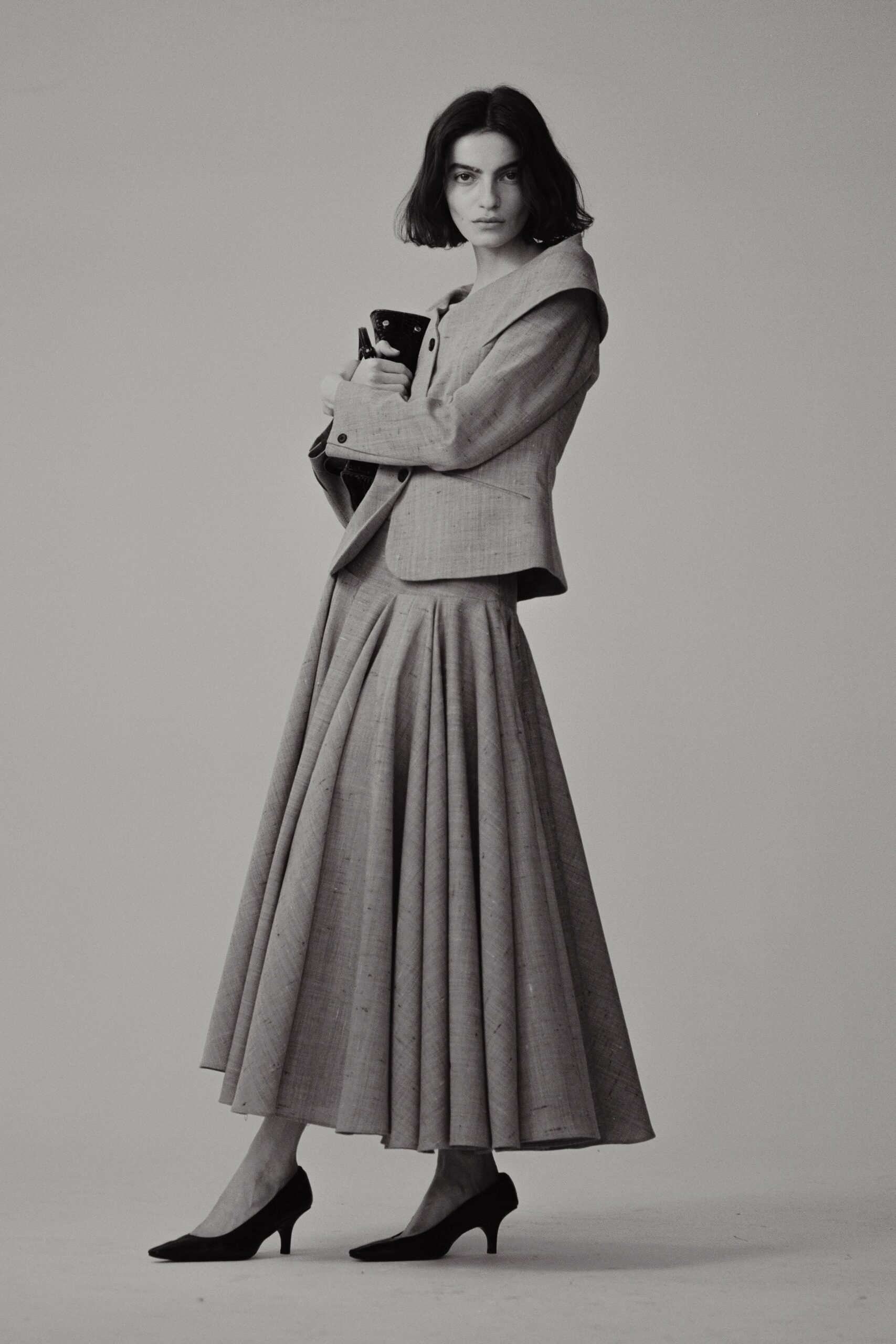 gray blazer and pleated skirt