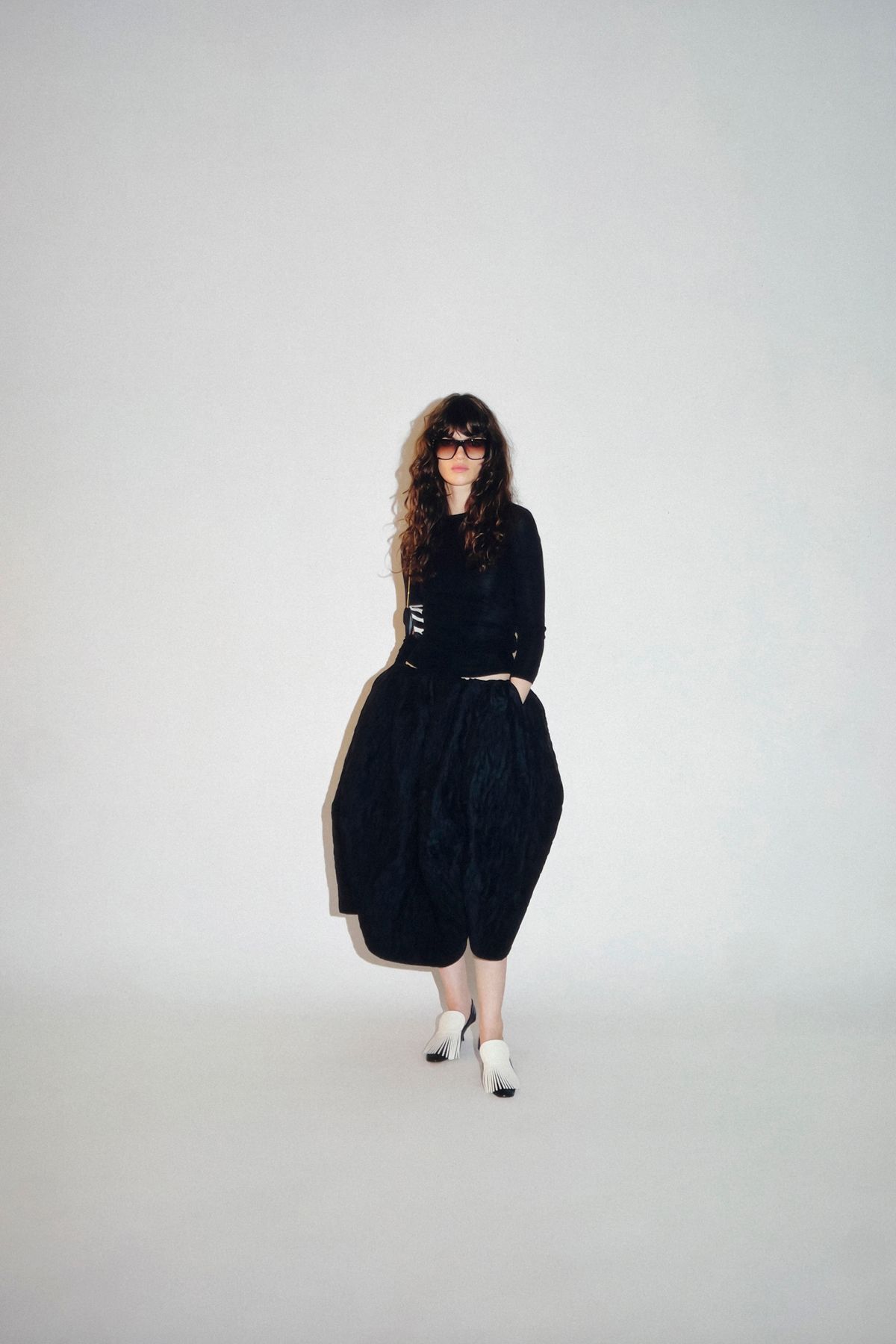 black fitted top with pleated skirt