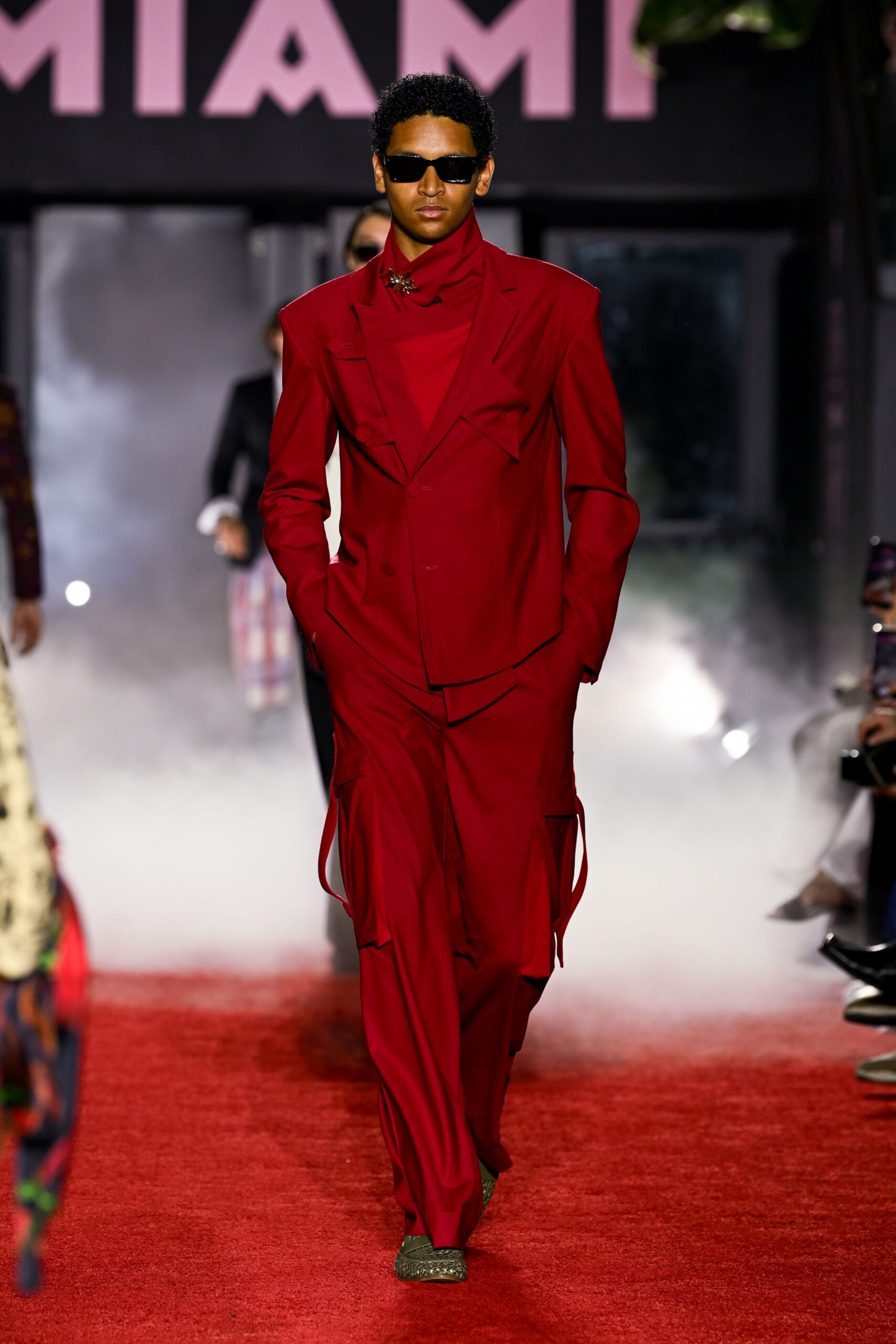 red long-sleeve collared fitted zippered pockets suit