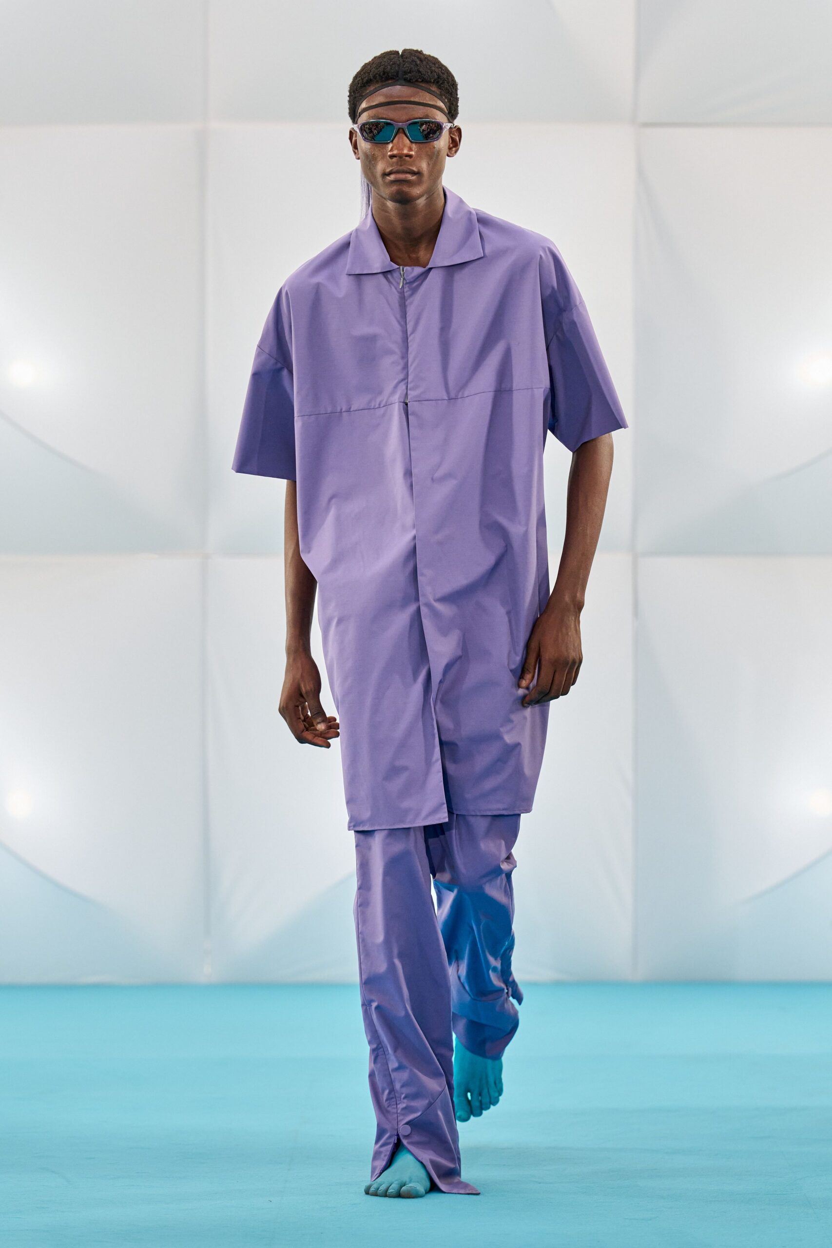 purple vinyl jumpsuit with sunglasses