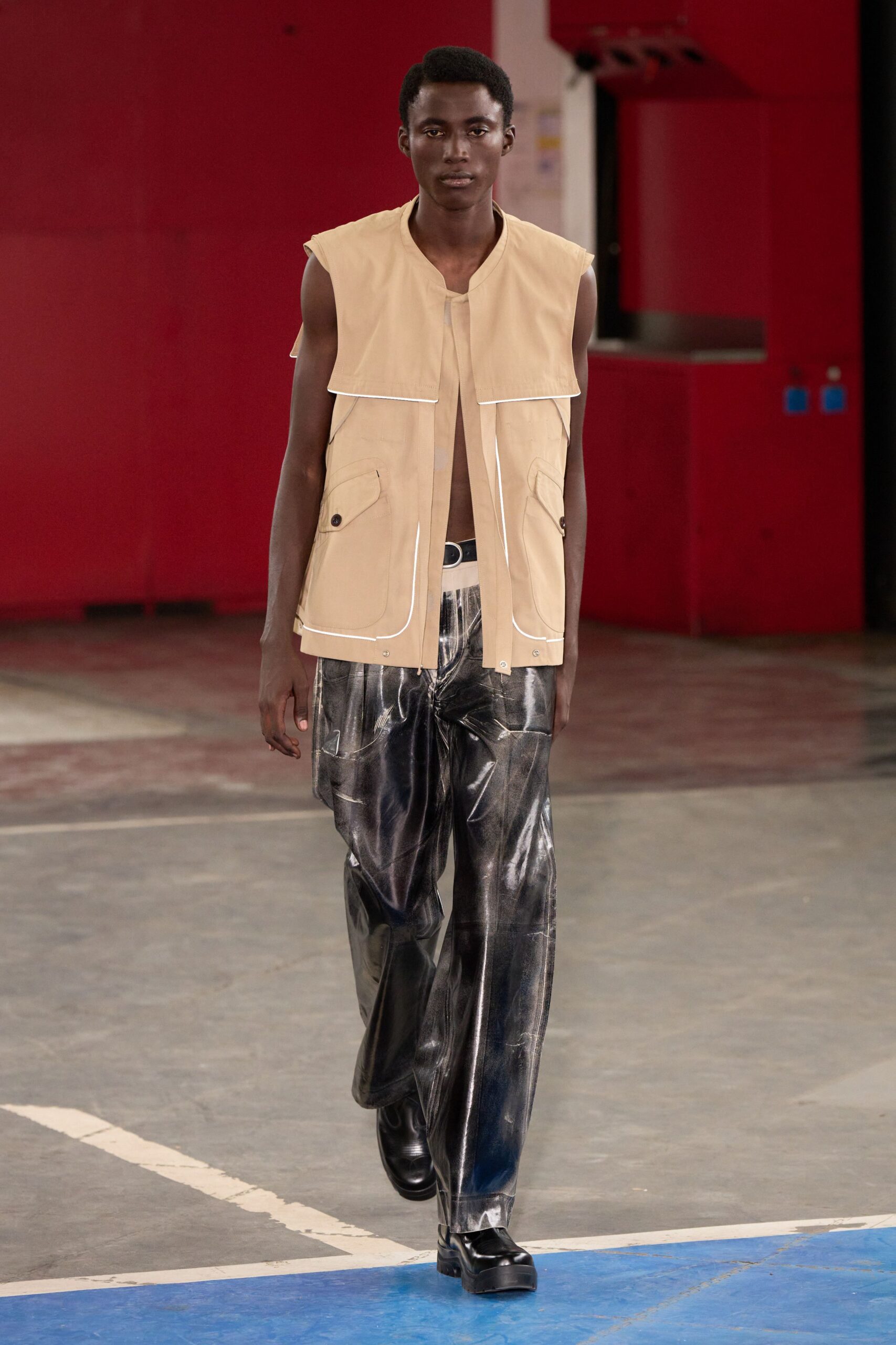 beige cotton vest with black vinyl pants