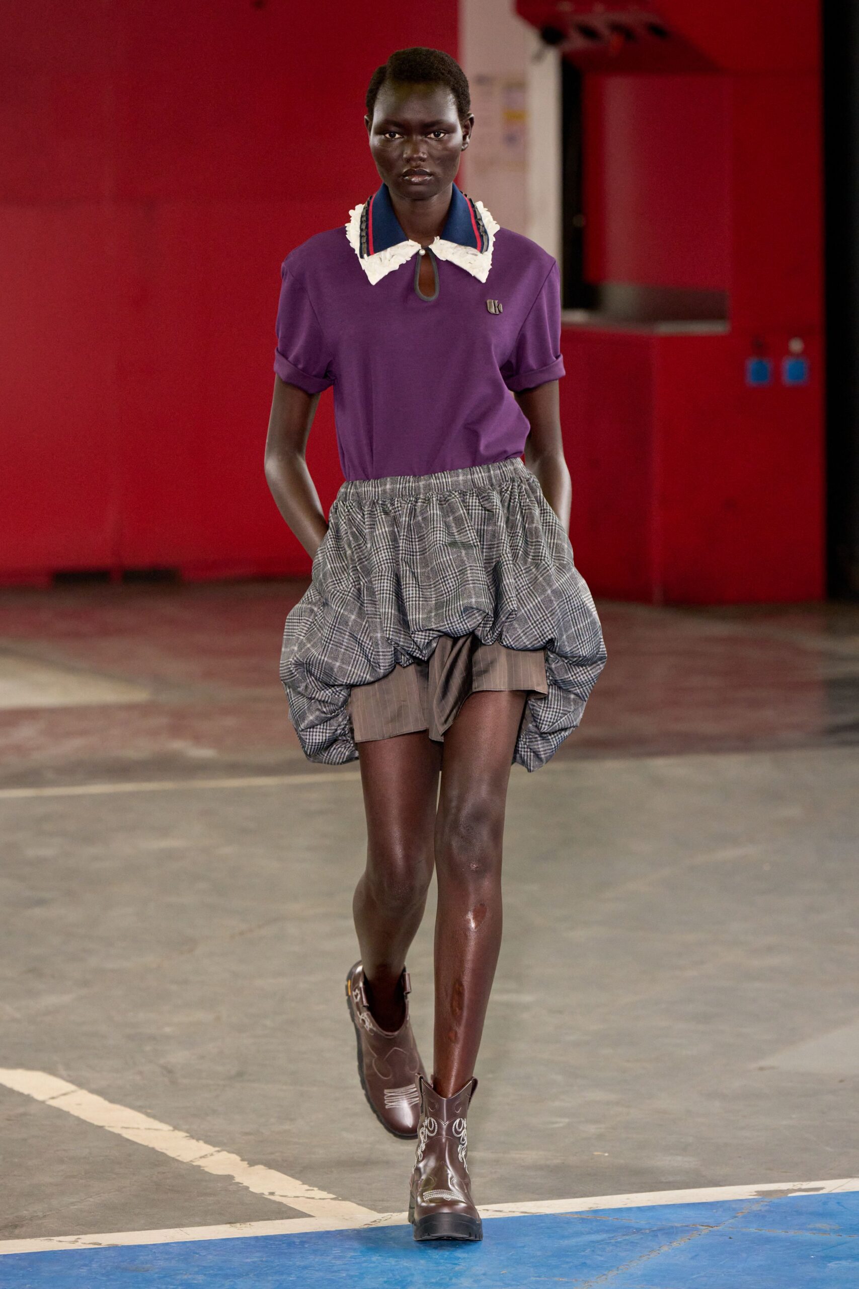 purple shirt gray pleated skirt
