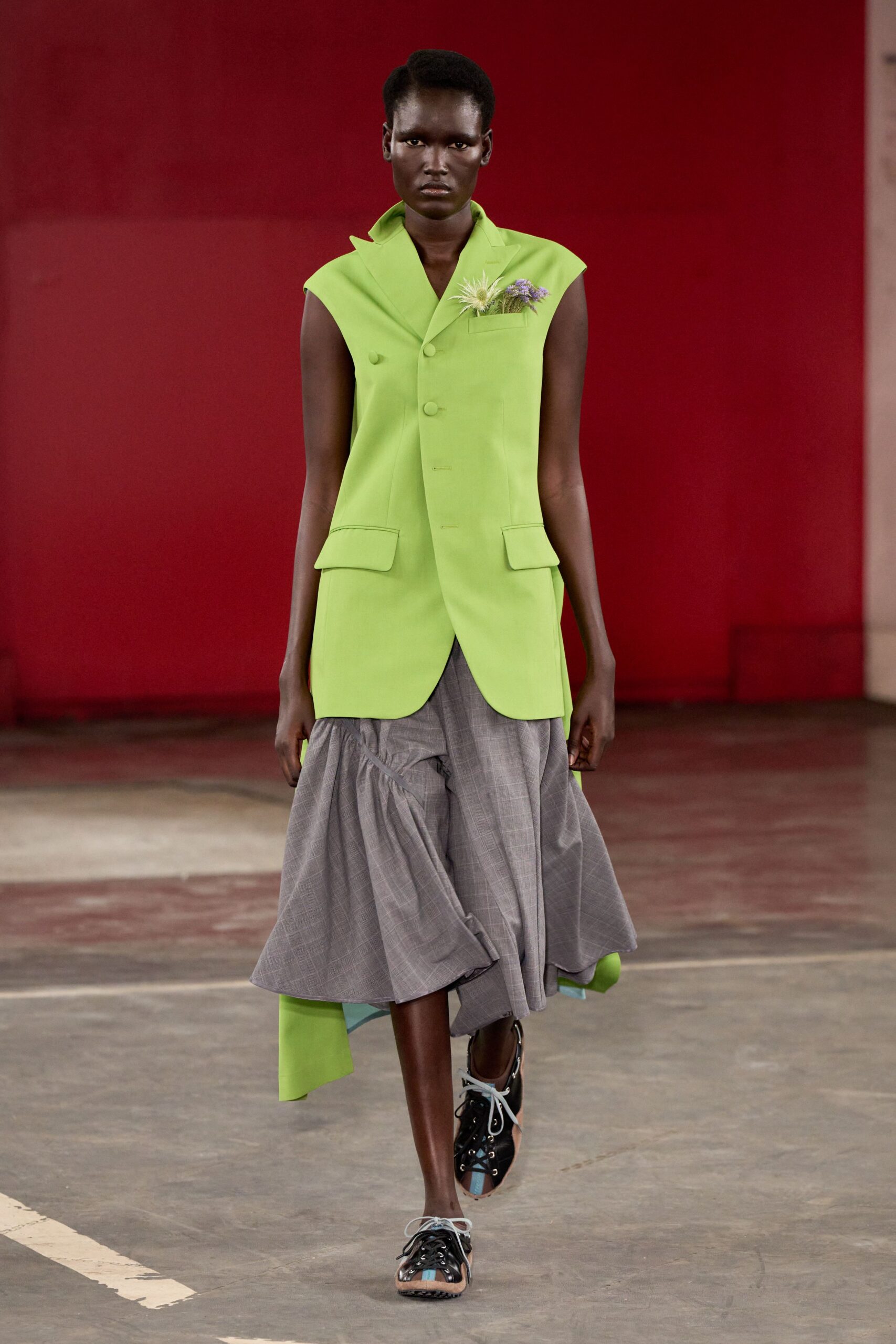 green tailored blazer gray pleated skirt