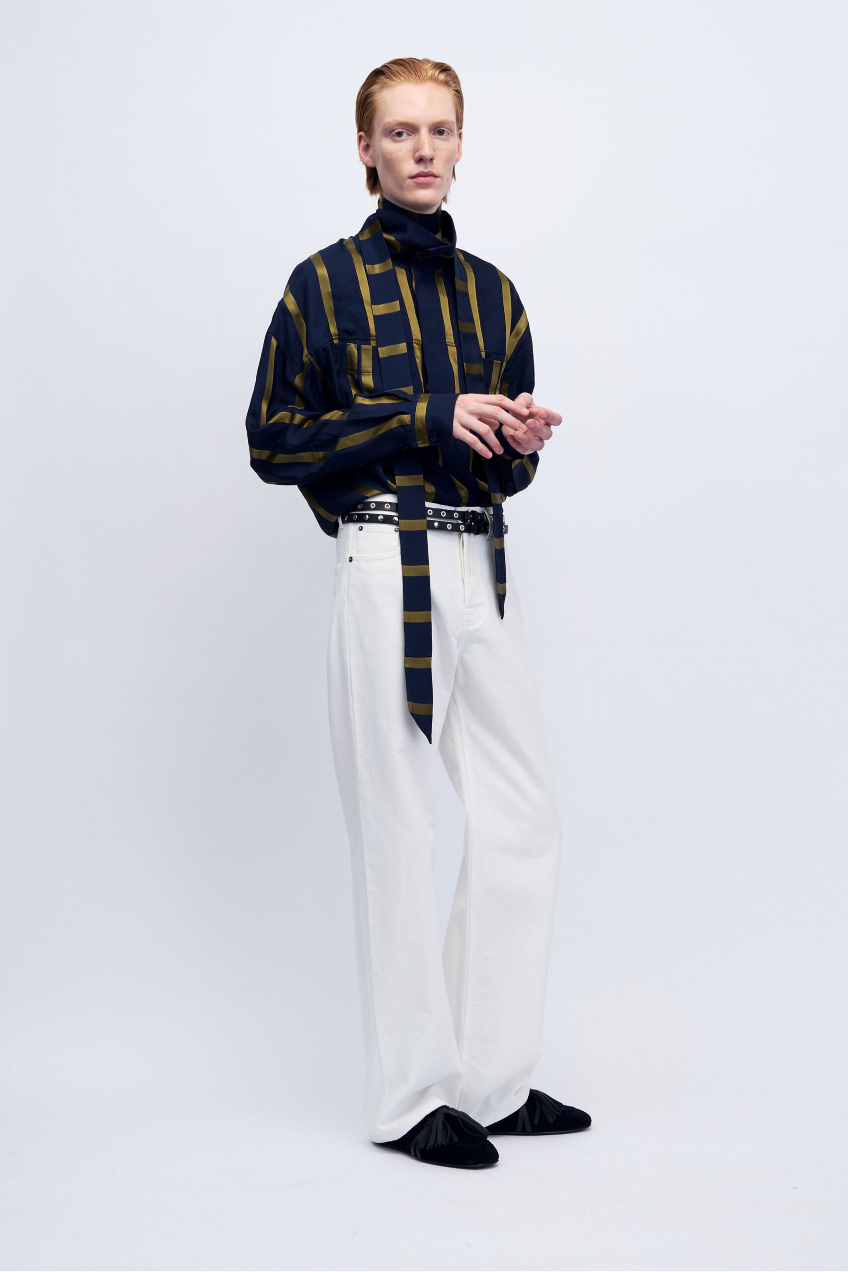 blue green striped shirt with white pants