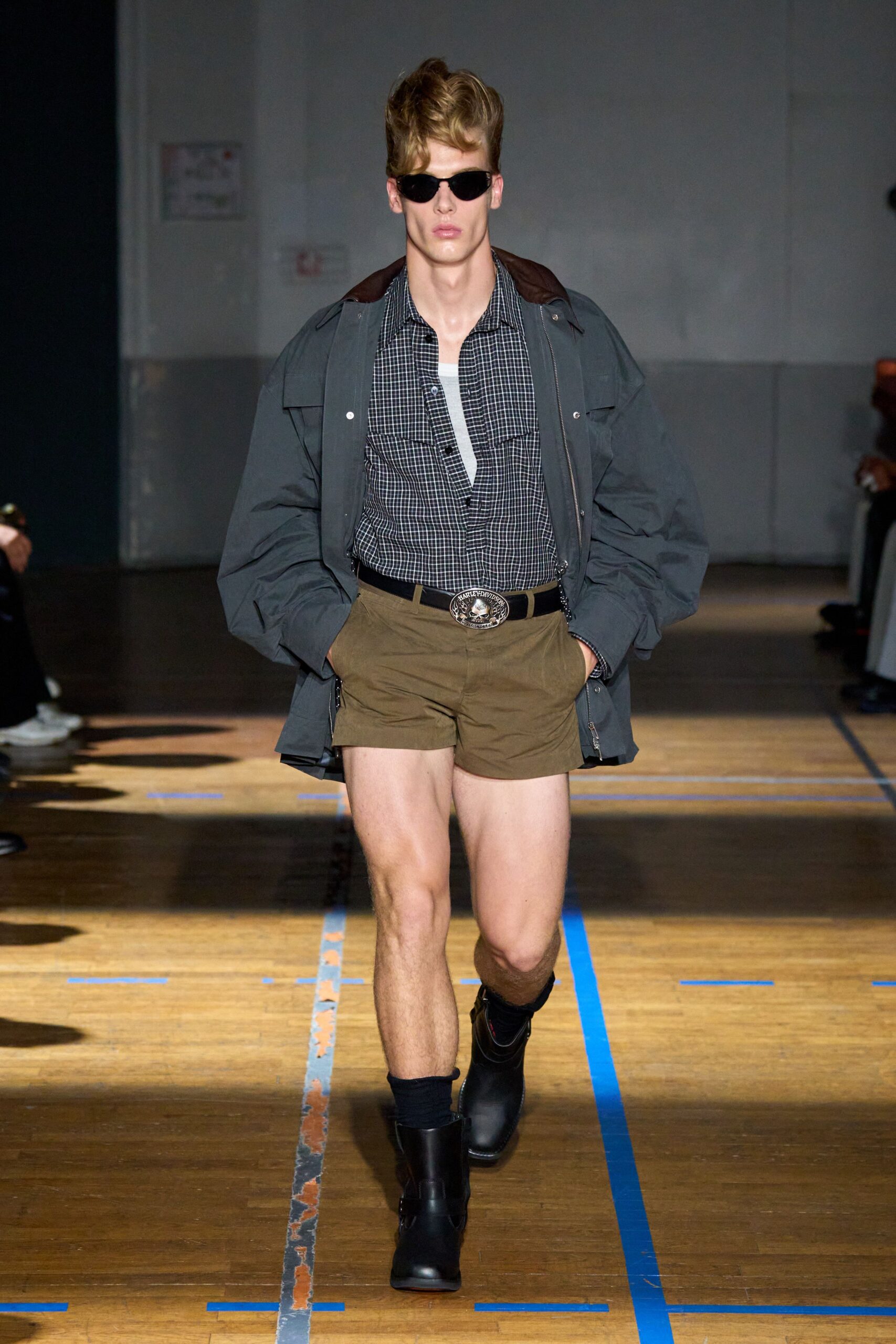 gray jacket black shirt brown shorts