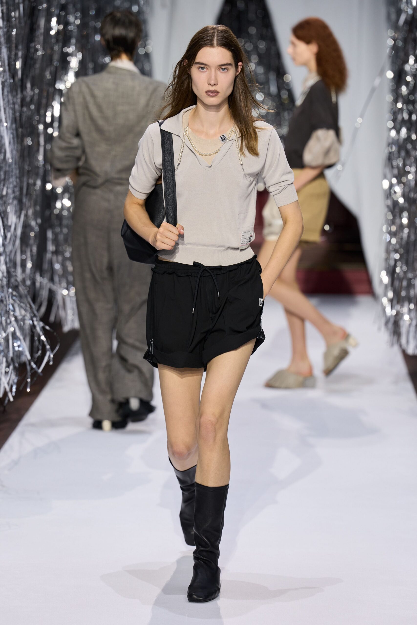 beige fitted top black shorts