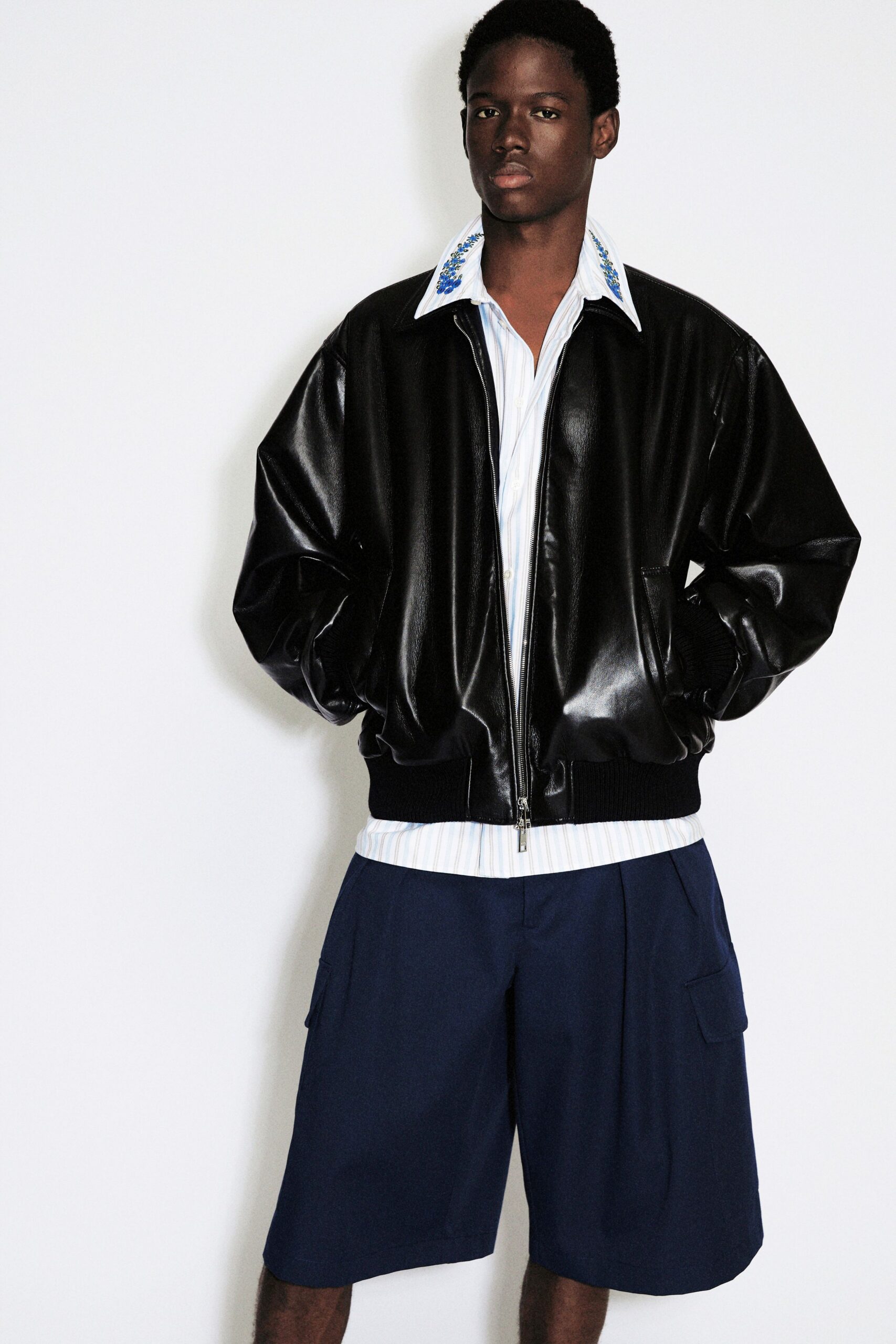 black leather jacket with blue shorts