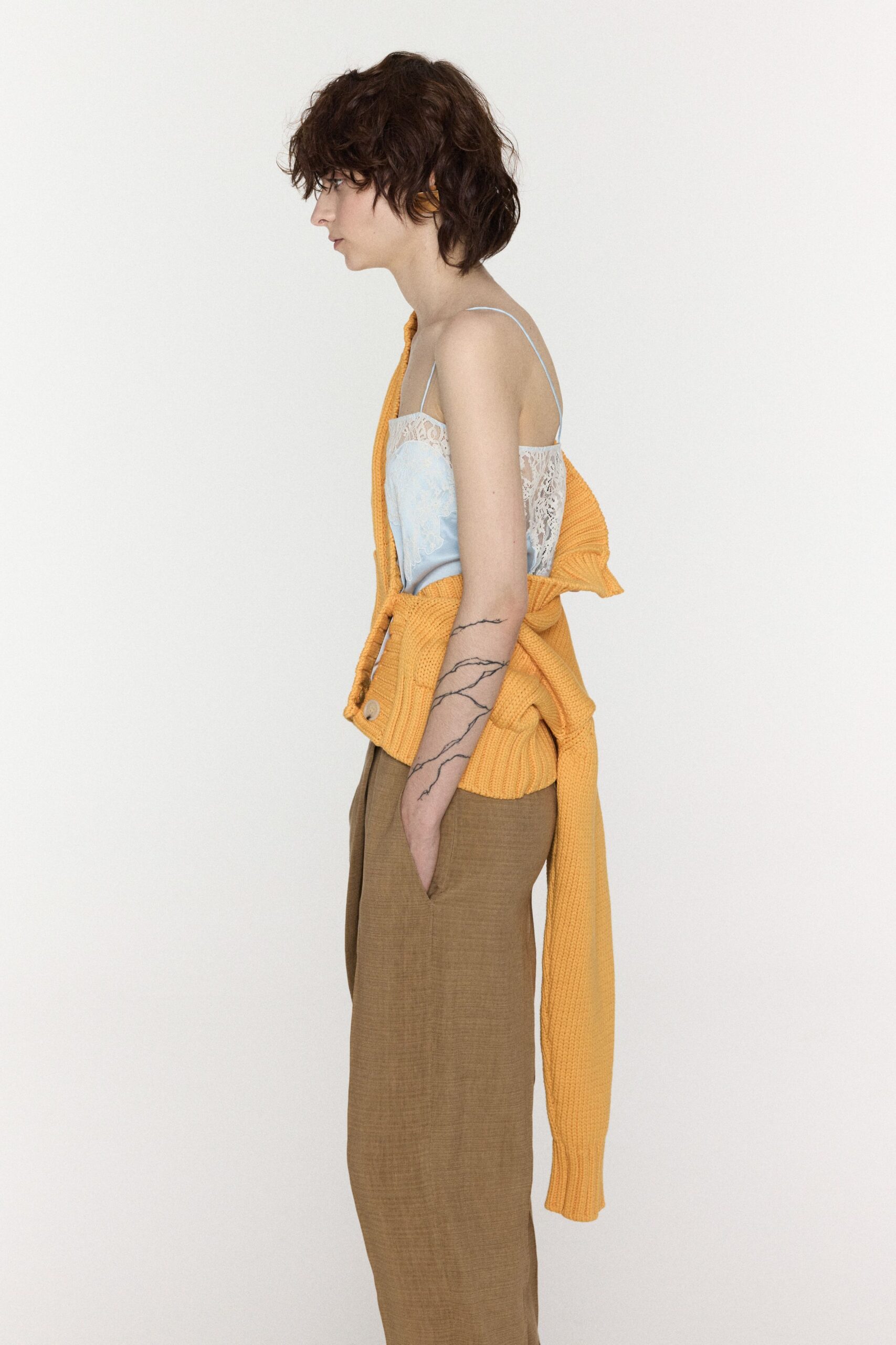 blue top orange cardigan beige pants