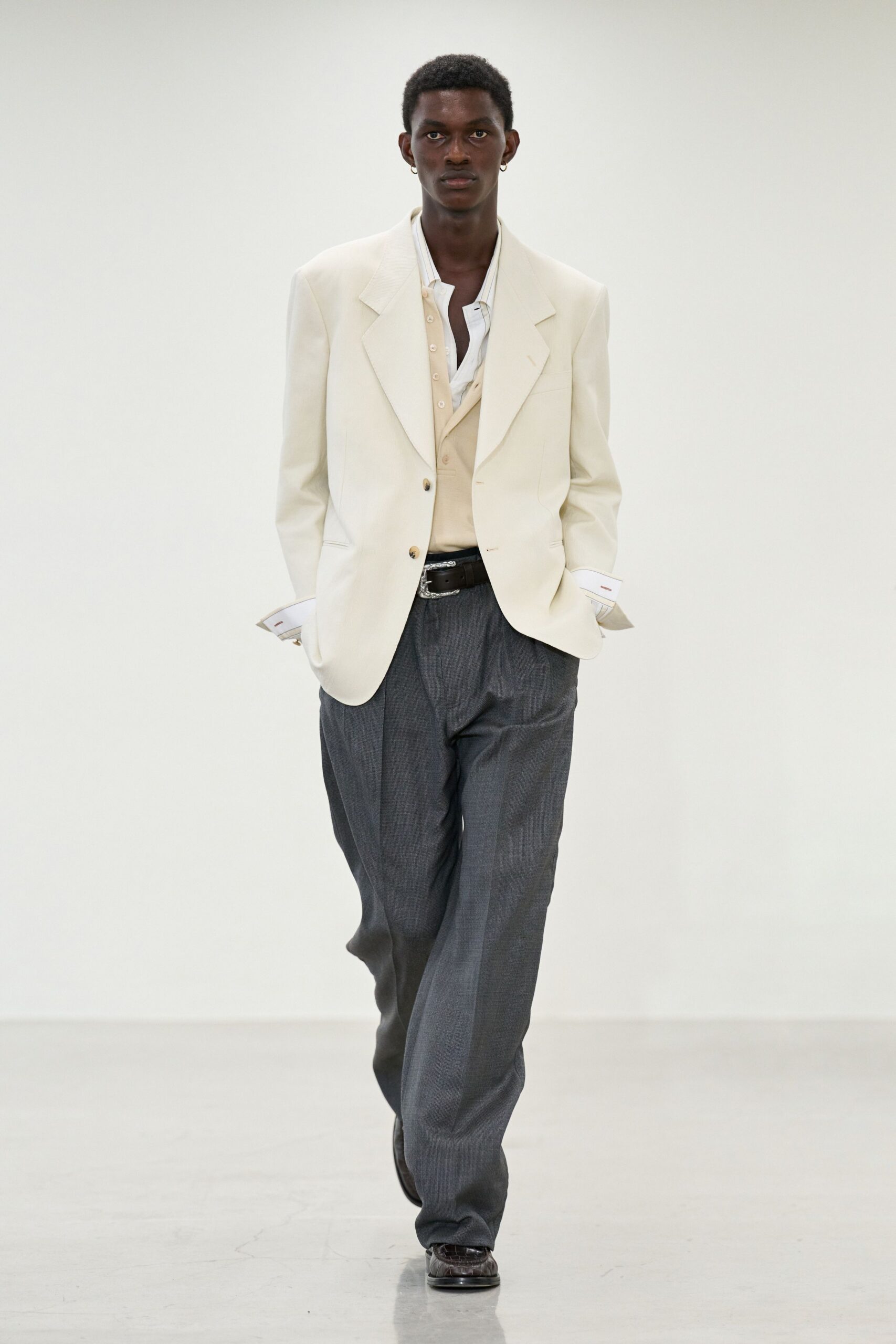white blazer beige vest gray pants