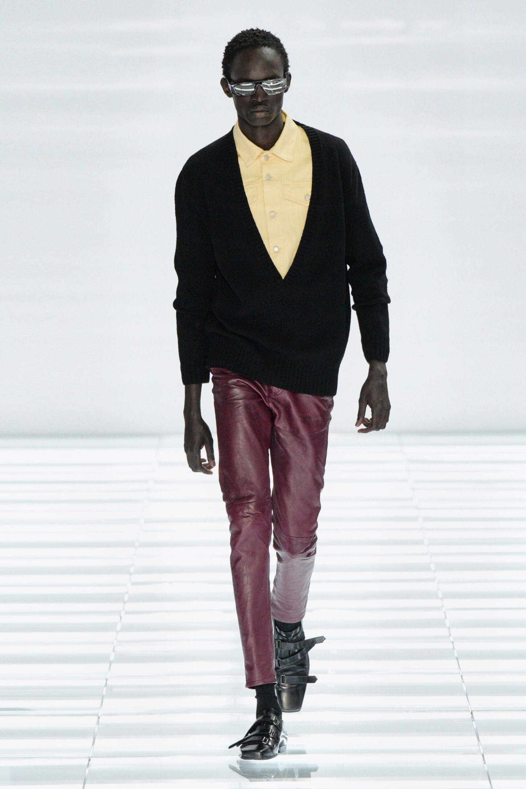 black sweater yellow shirt red pants