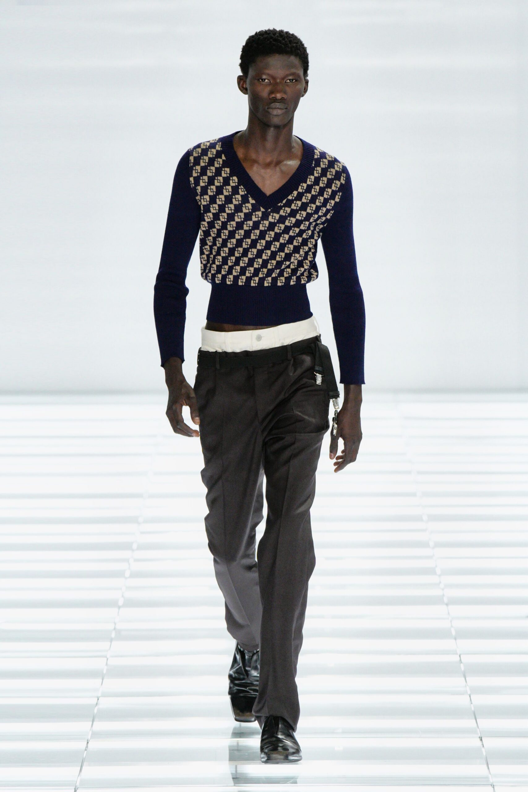 blue embroidered sweater with black pants