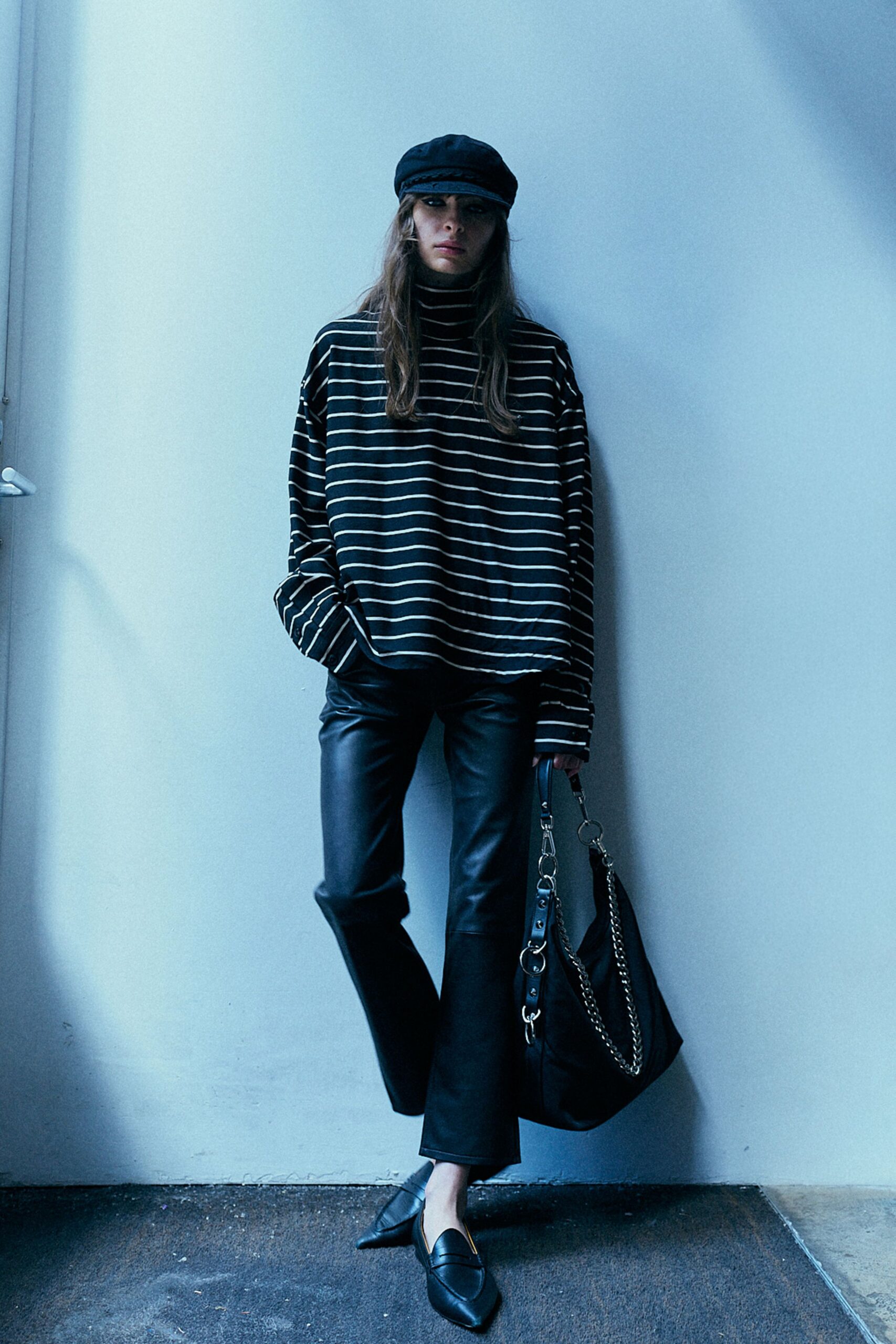 black striped relaxed top with leather pants