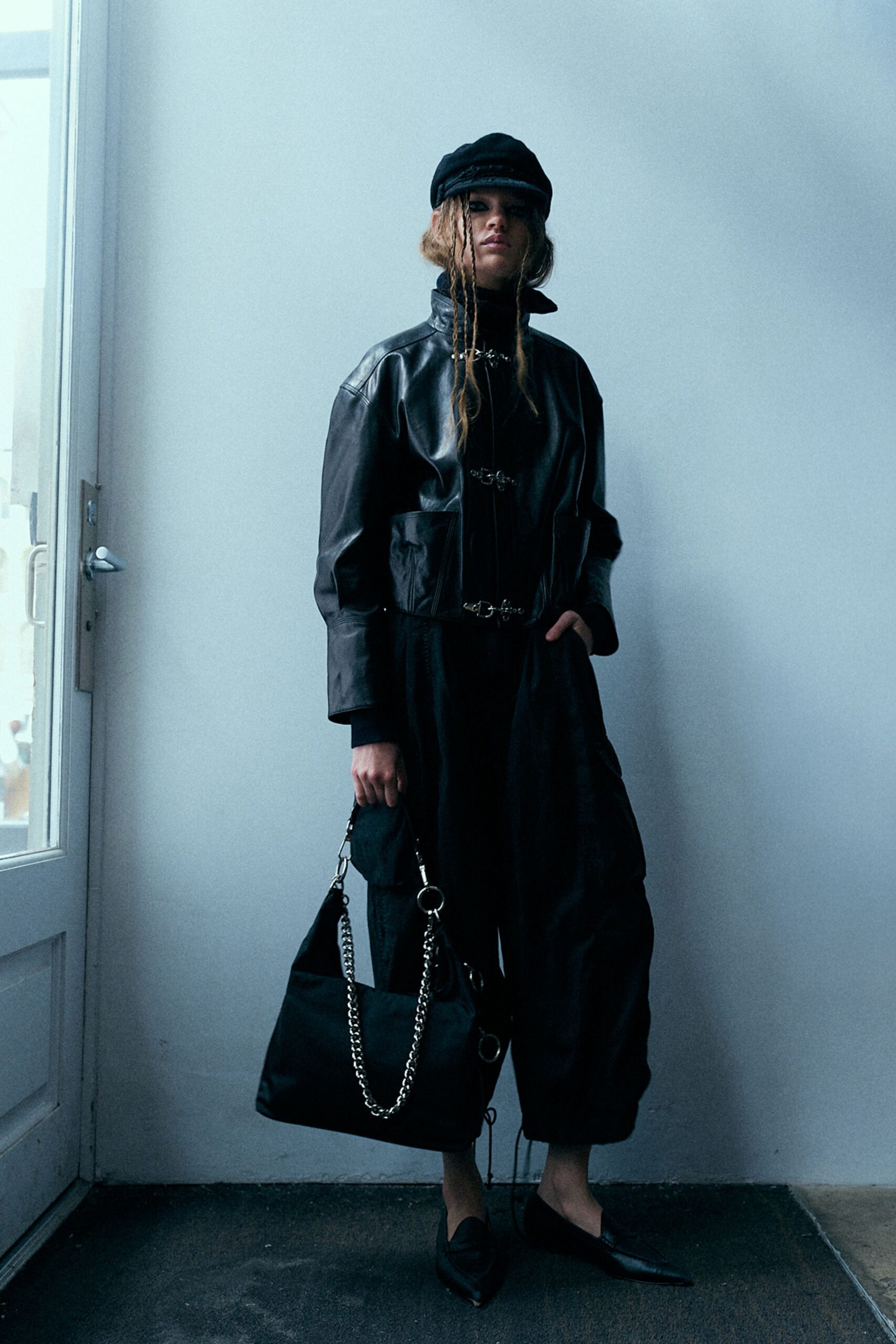 black leather jacket with wide-leg pants