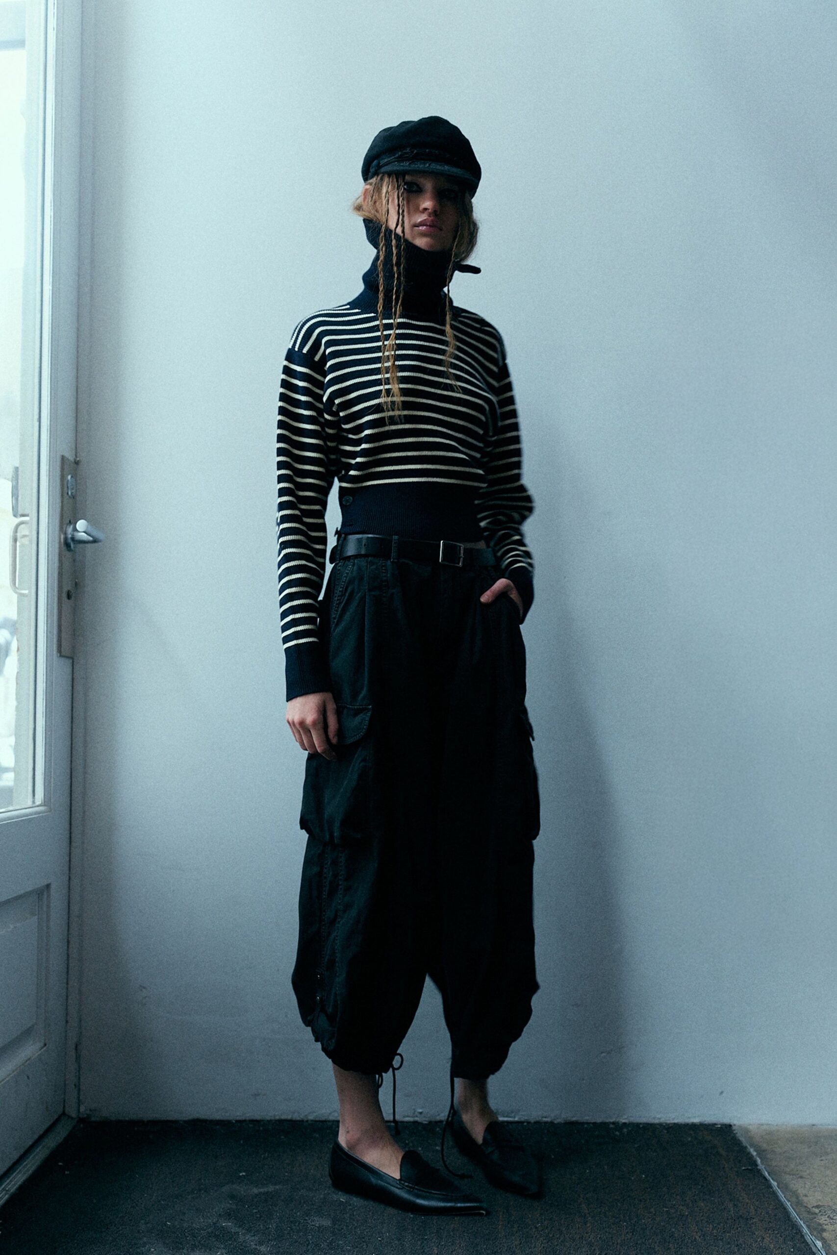 black striped turtleneck top with cargo pants