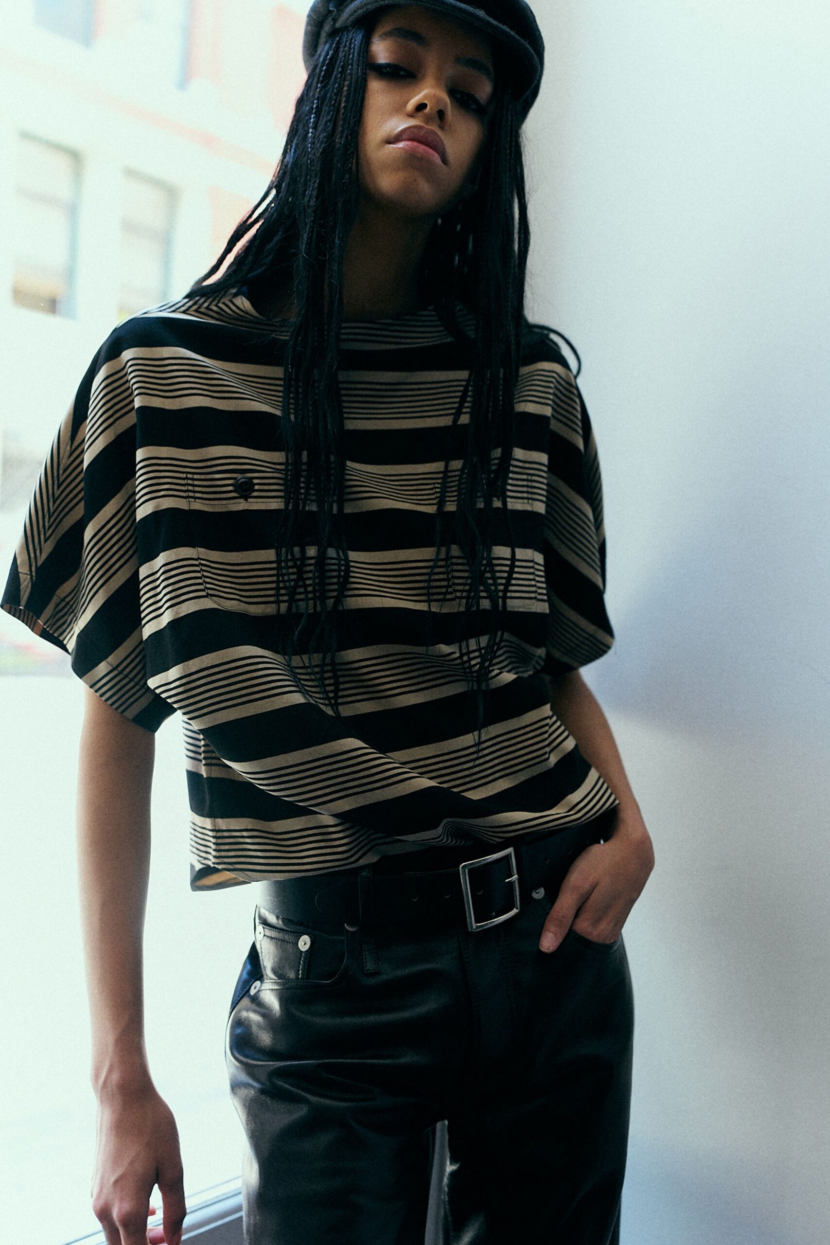 black and beige striped top with leather pants