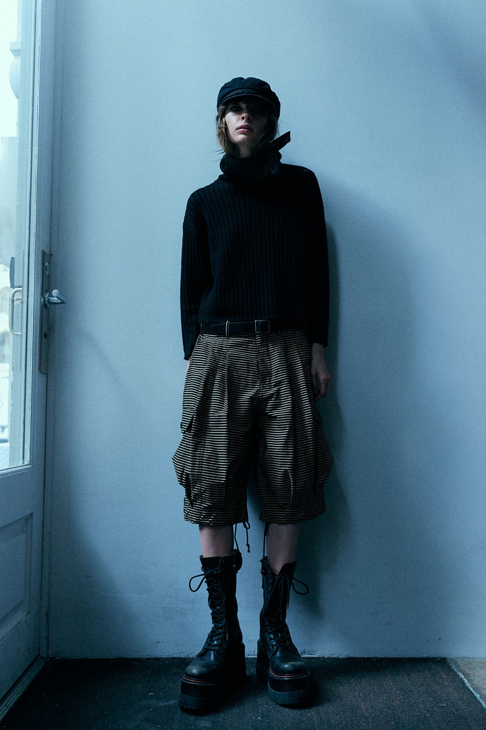 black turtleneck top with cargo shorts