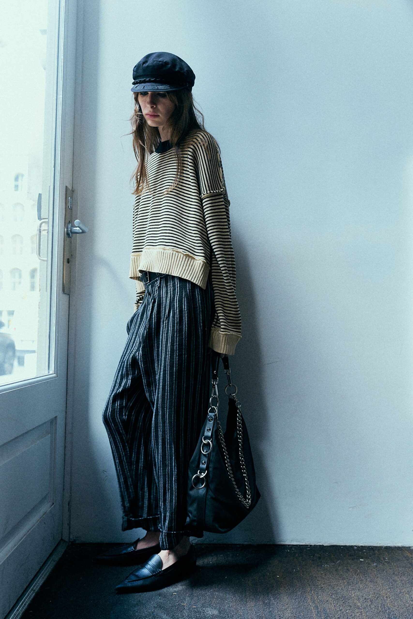 beige striped cropped sweater with black pants