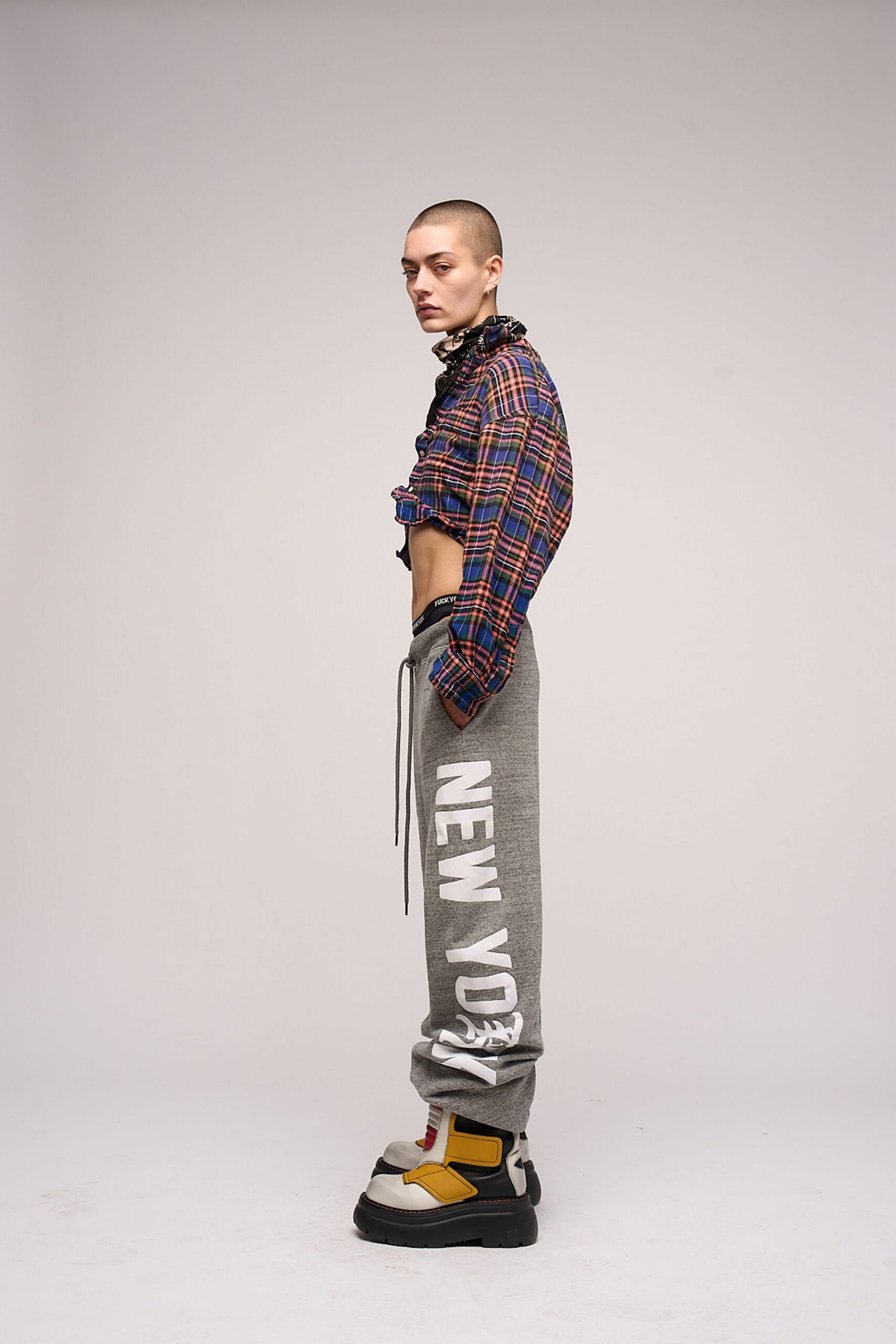 checked shirt gray pants chunky shoes