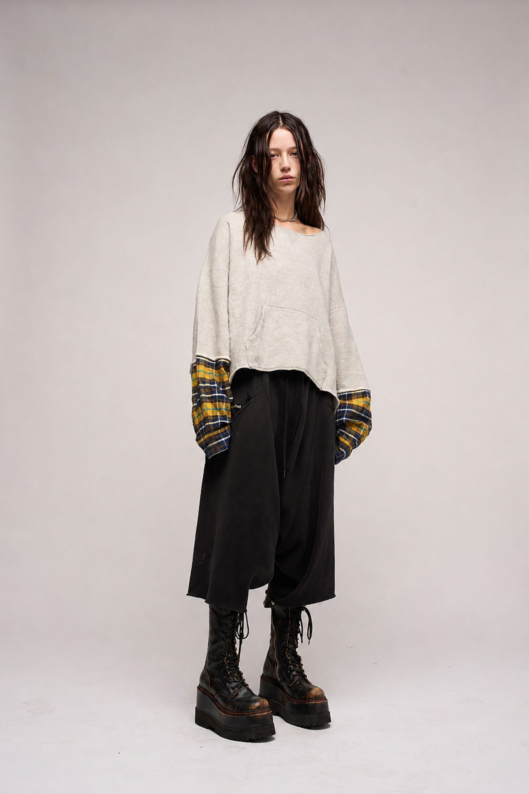 gray relaxed top with black pants and boots
