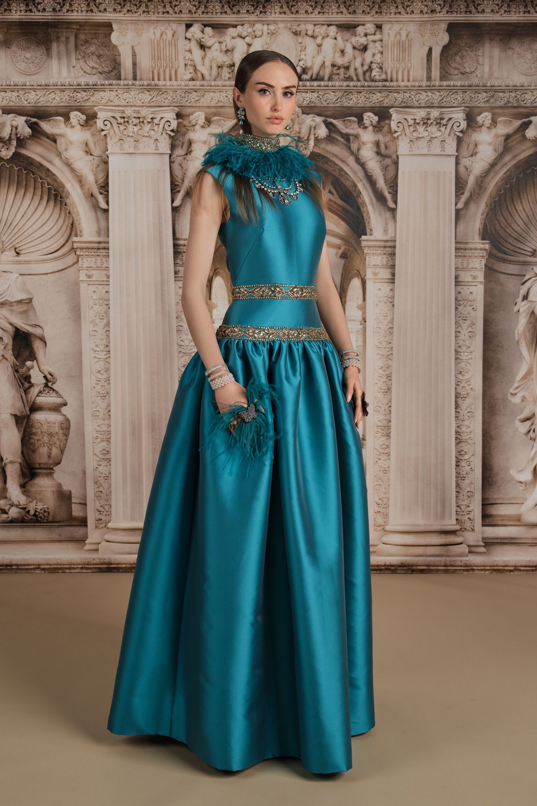 teal satin sleeveless high-neck fitted pleated belted gown