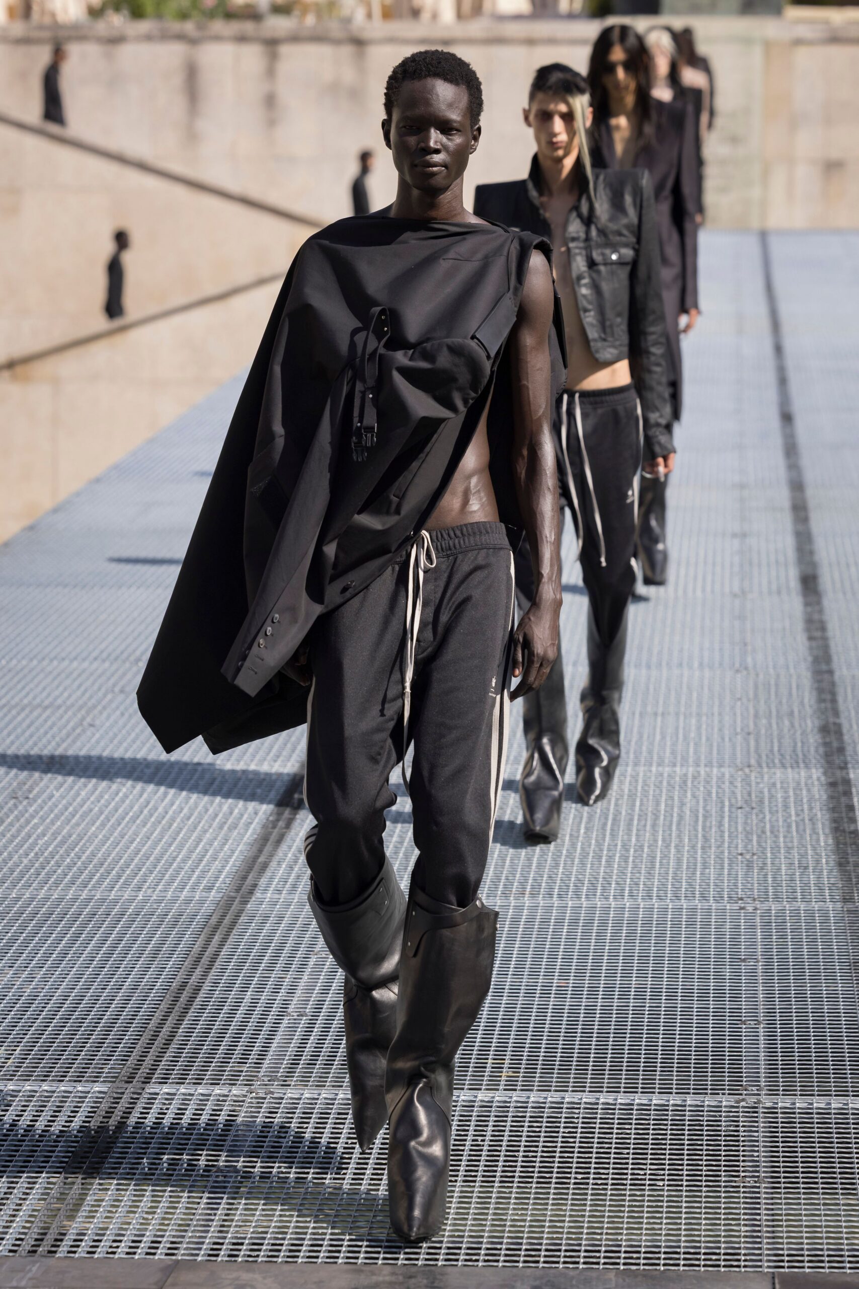 black cape and fitted pants