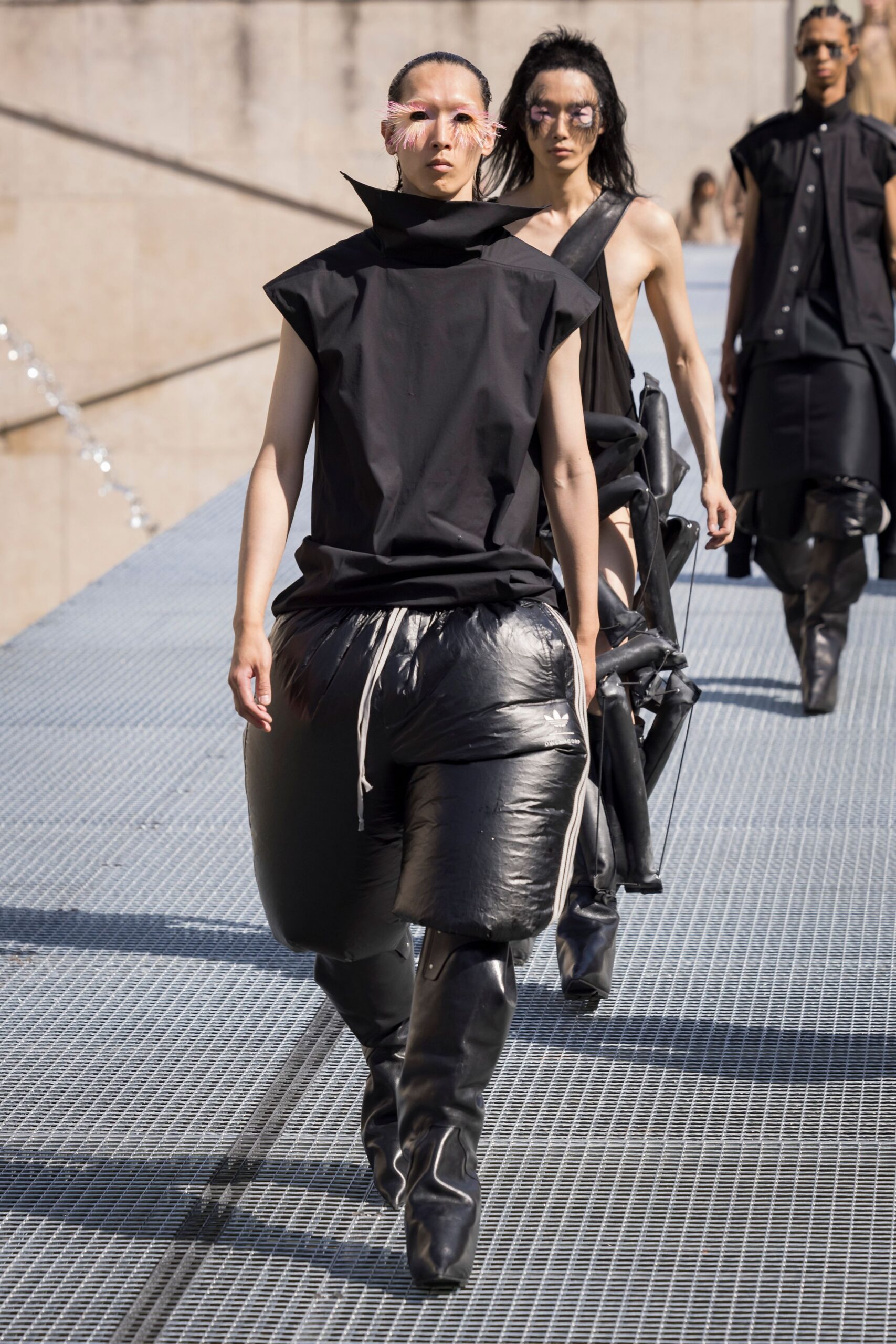 black relaxed top with shiny pants