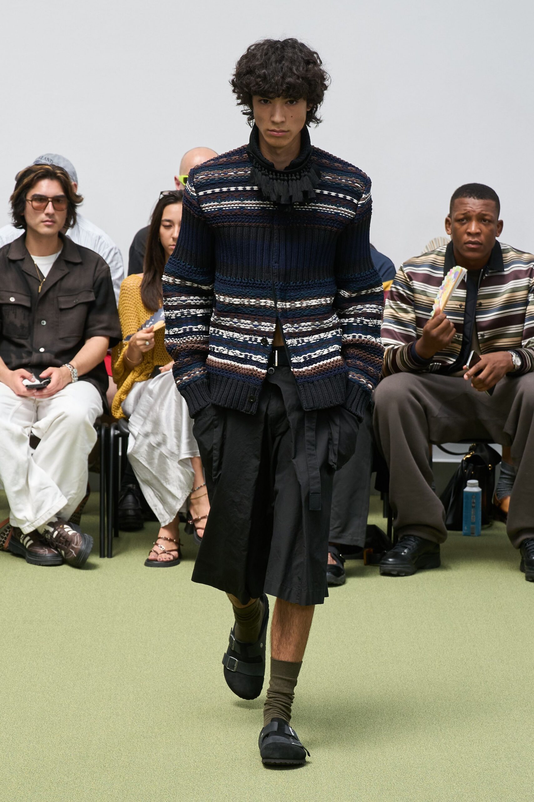 blue striped wool sweater with black shorts