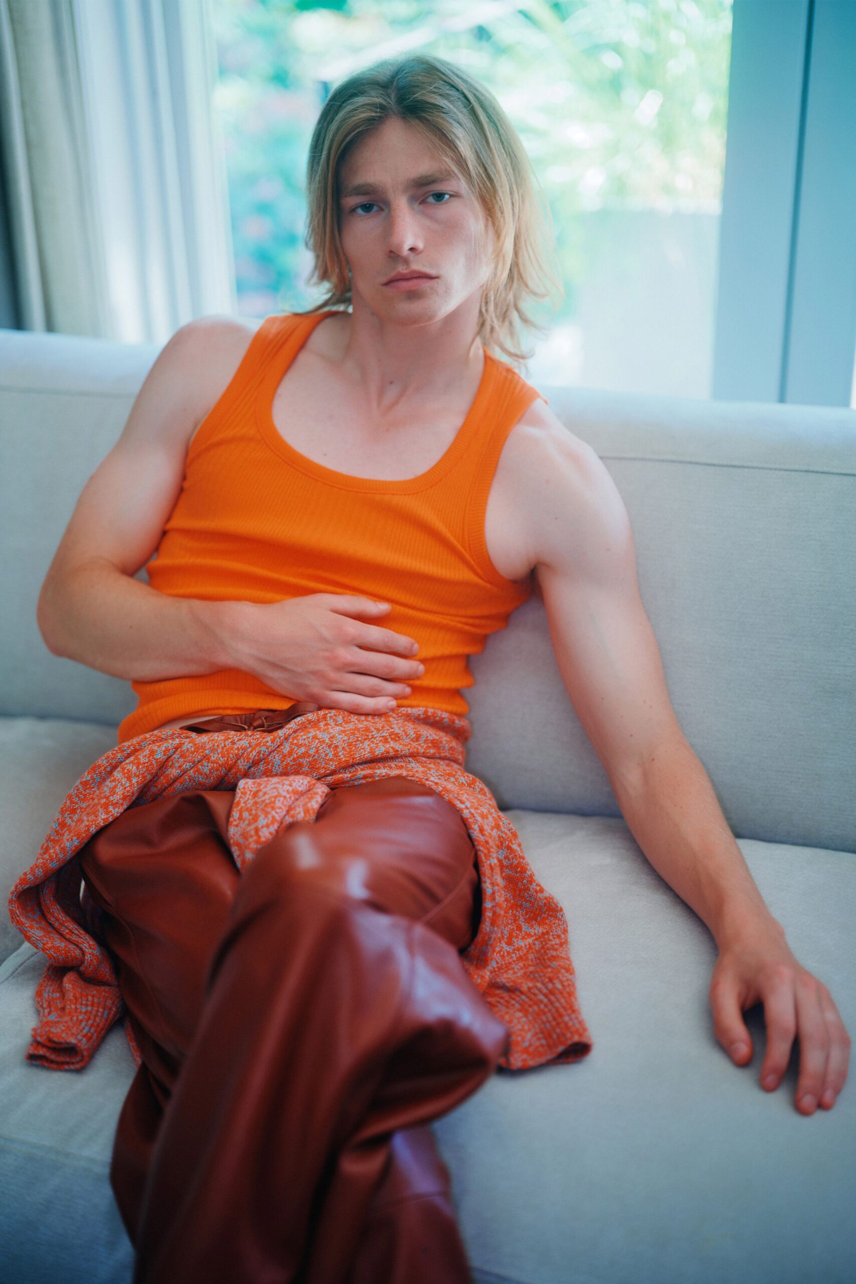 orange tank-top with brown leather pants