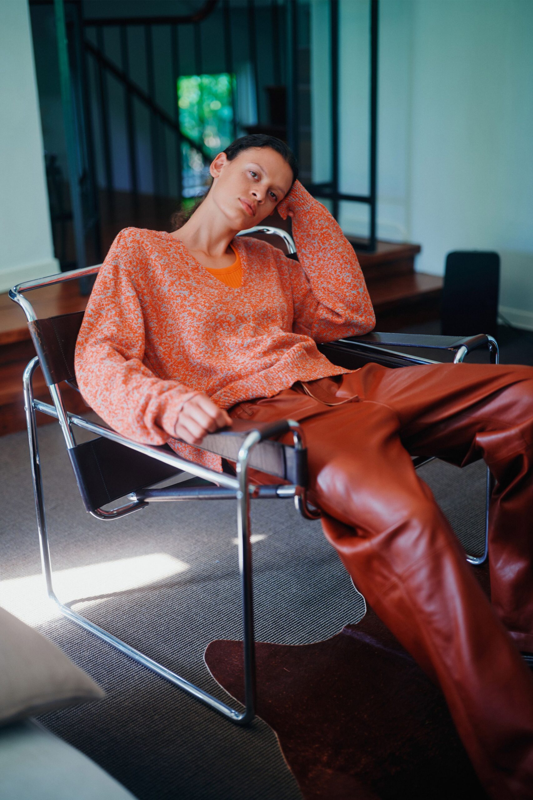 orange textured sweater brown leather pants