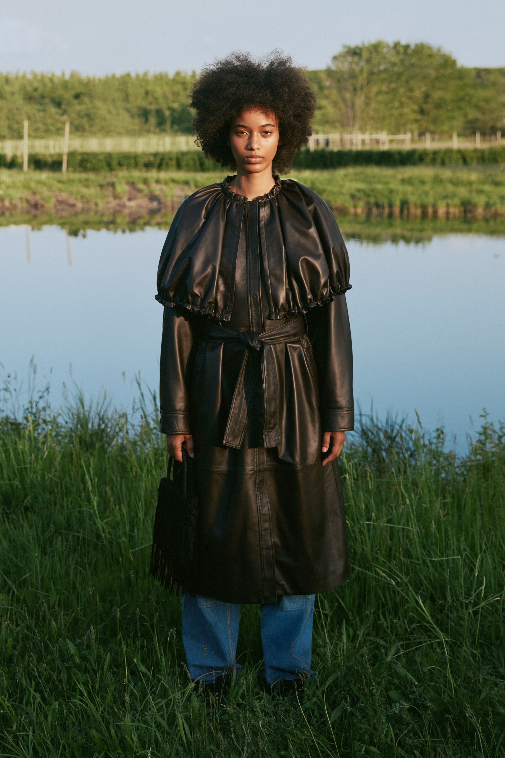 black leather long-sleeve collared fitted belted pleated coat