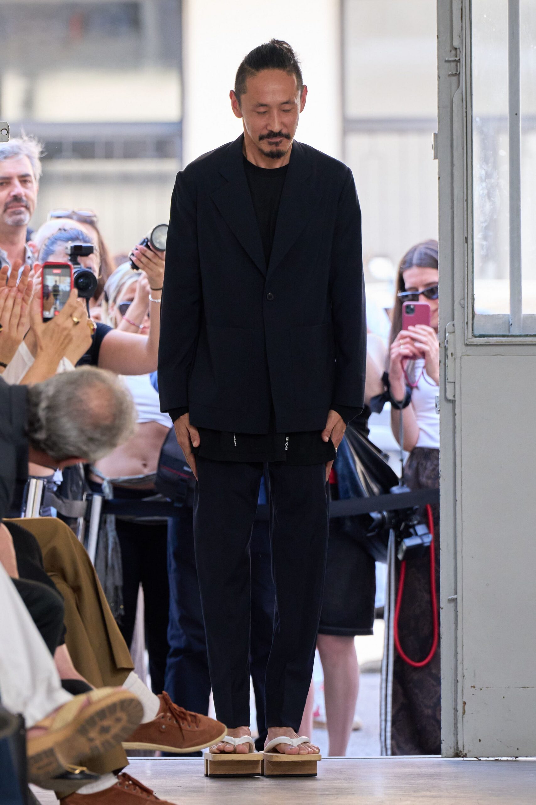 black tailored suit with beige shoes