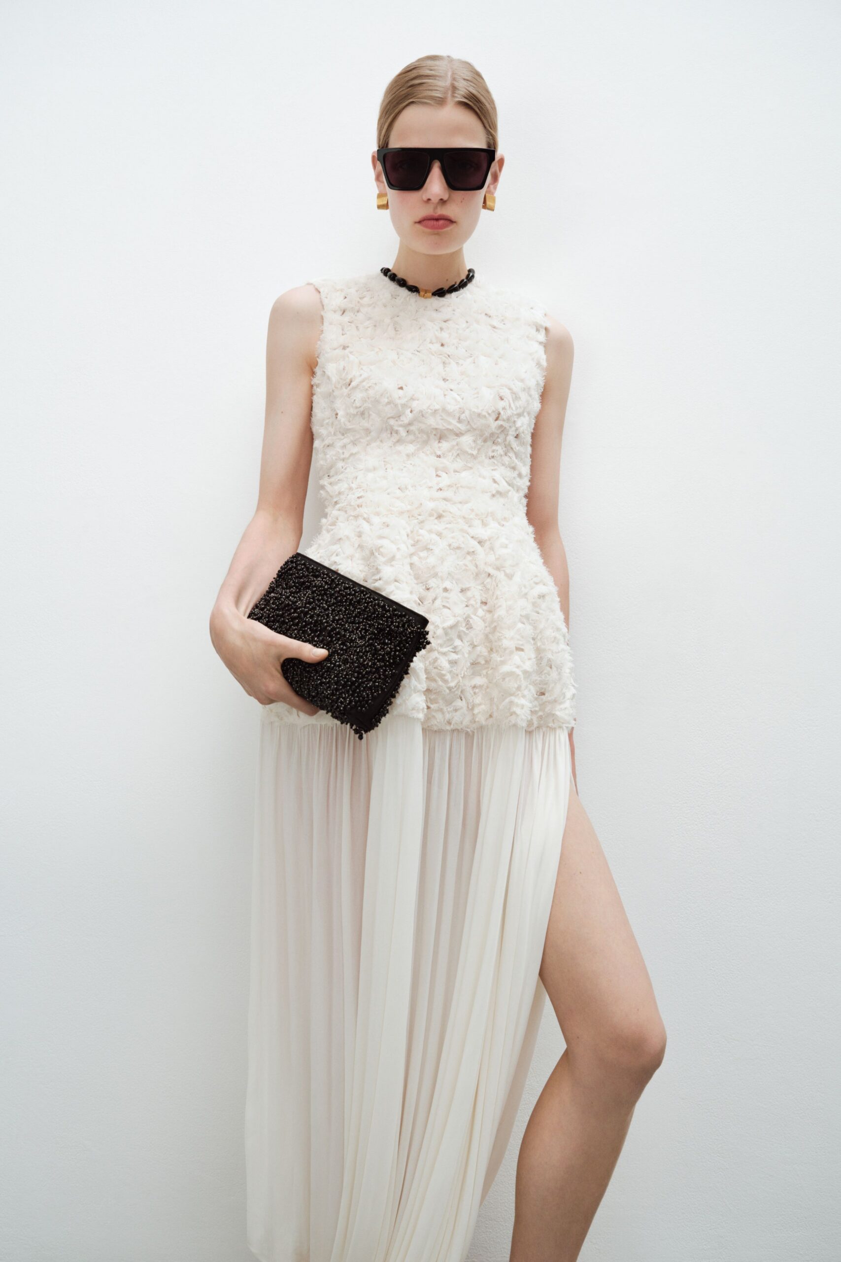 white silk sleeveless high-neck fitted pleated ruffled dress
