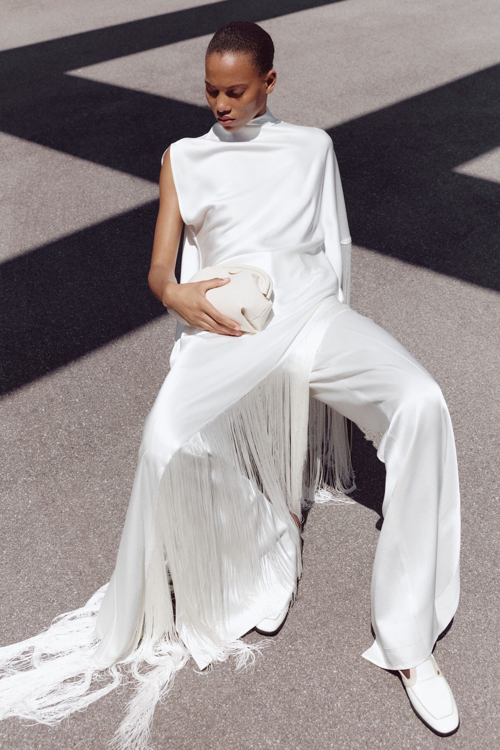 white silk sleeveless high-neck fitted fringed jumpsuit