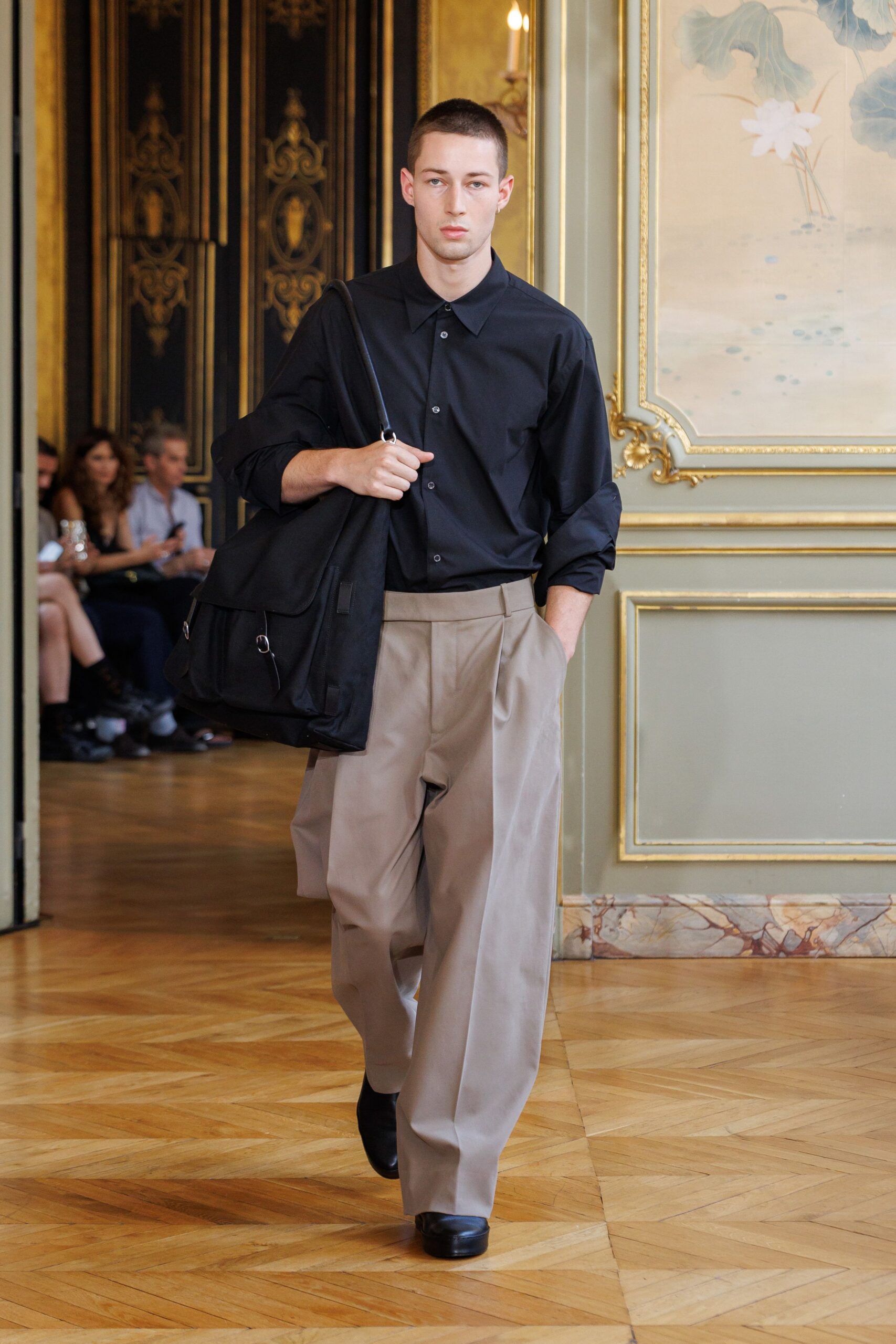 black shirt beige wide-leg pants