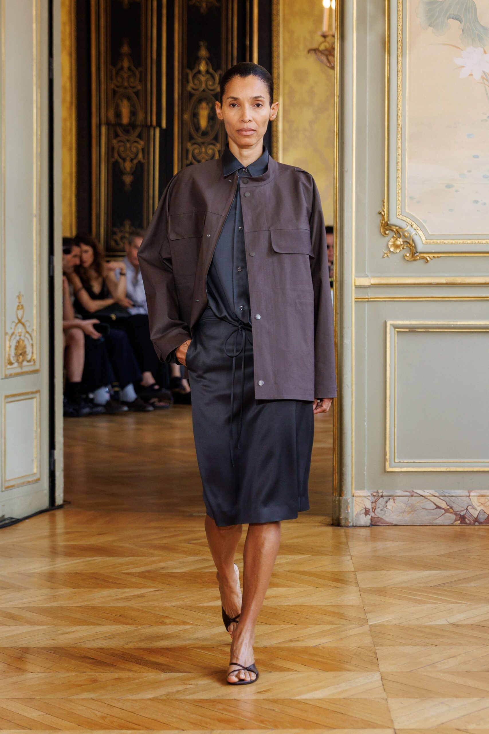 brown jacket black shirt black skirt sandals