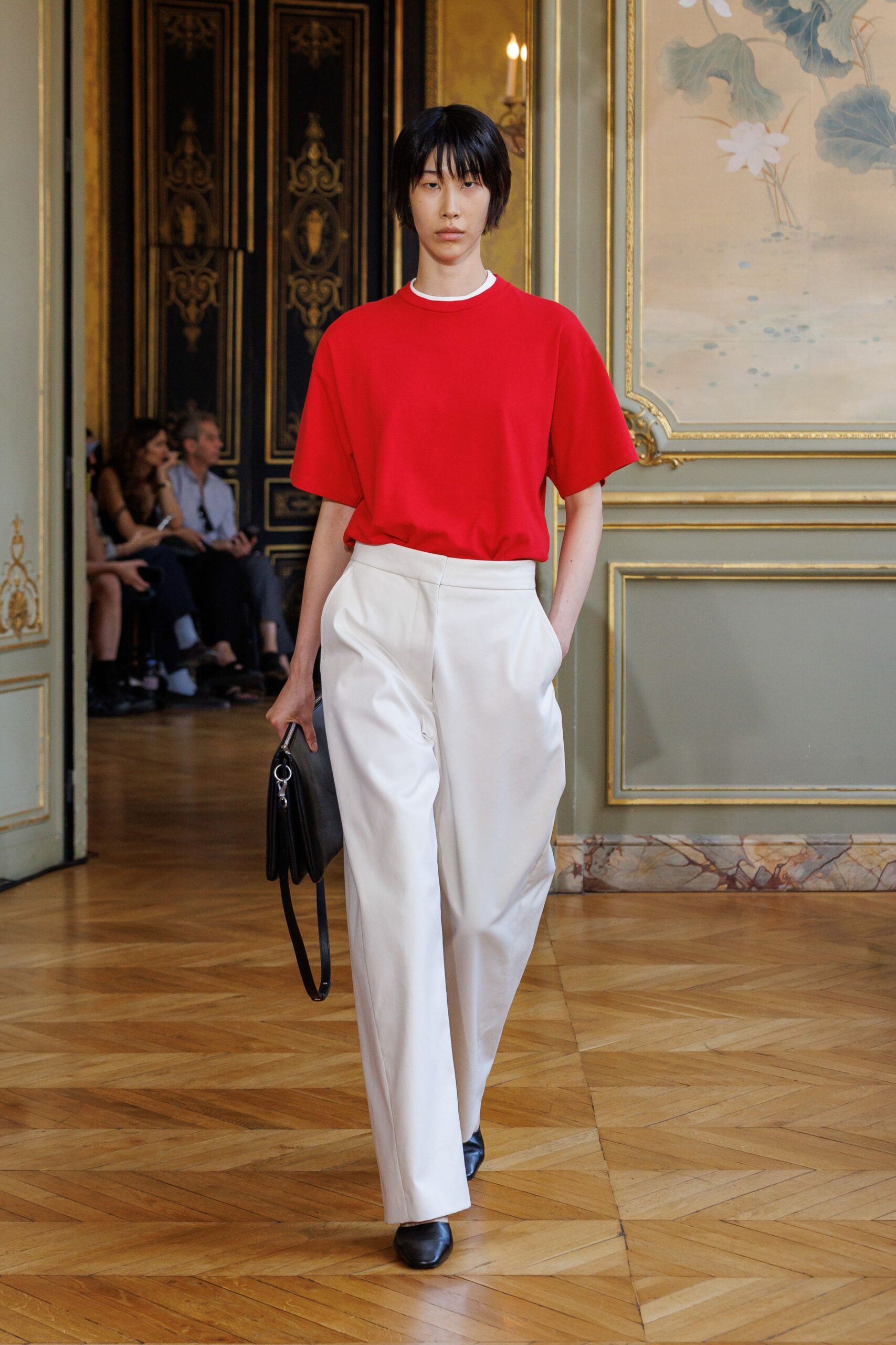 red relaxed top with white tailored pants