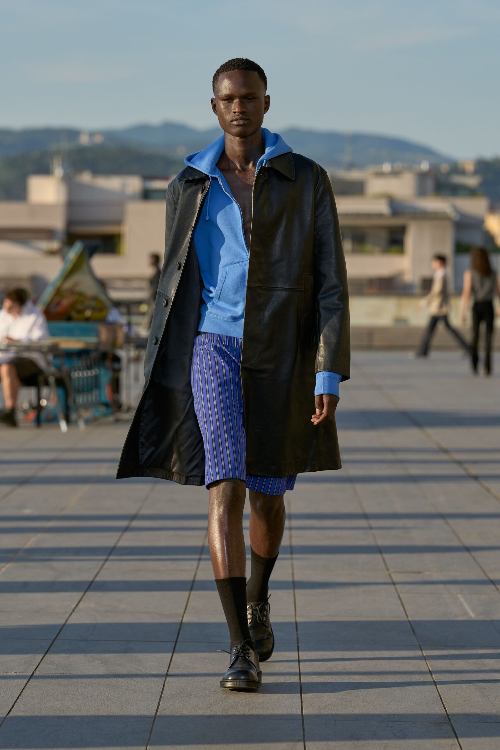 black leather long-sleeve collared structured coat