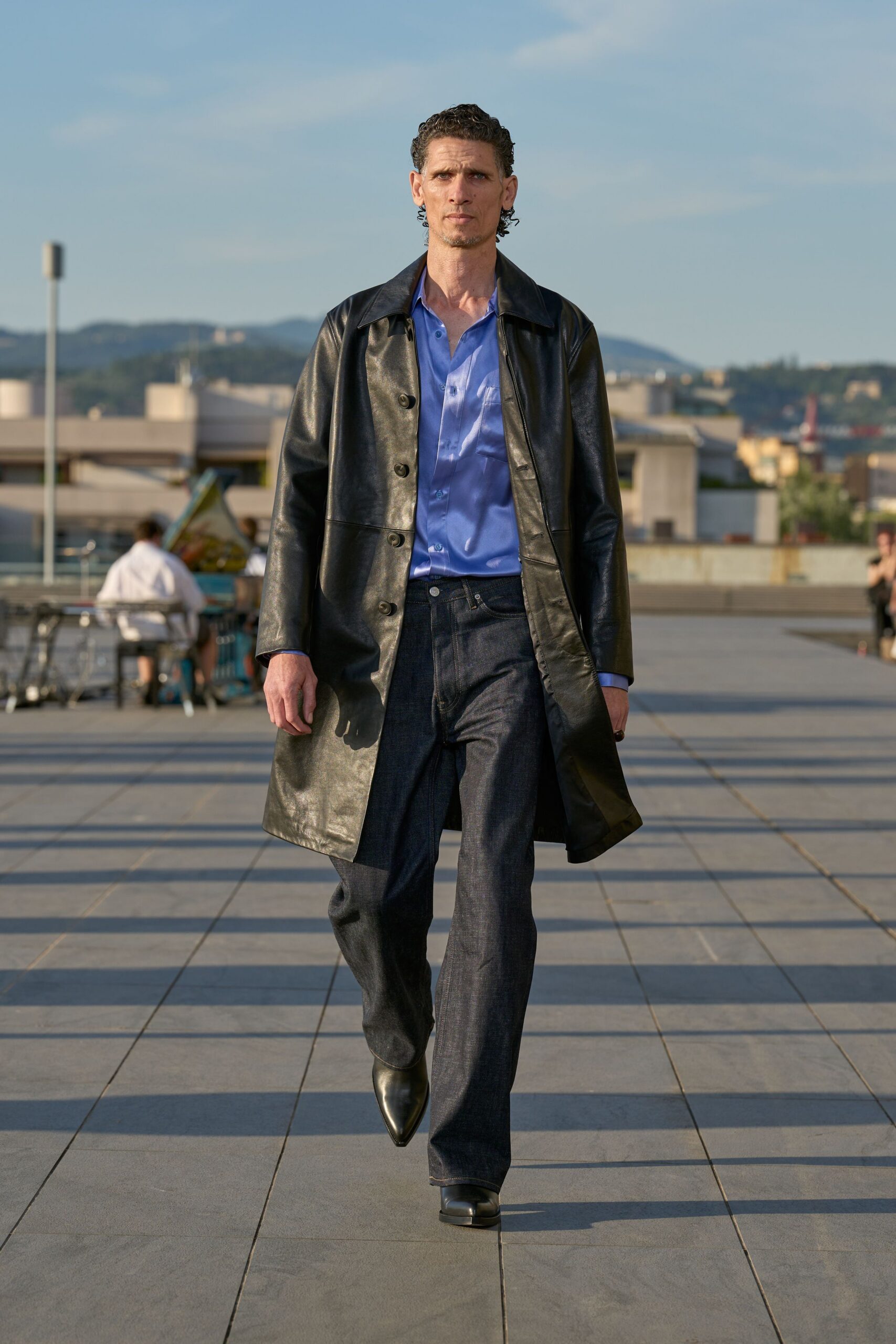 black leather coat blue shirt denim pants