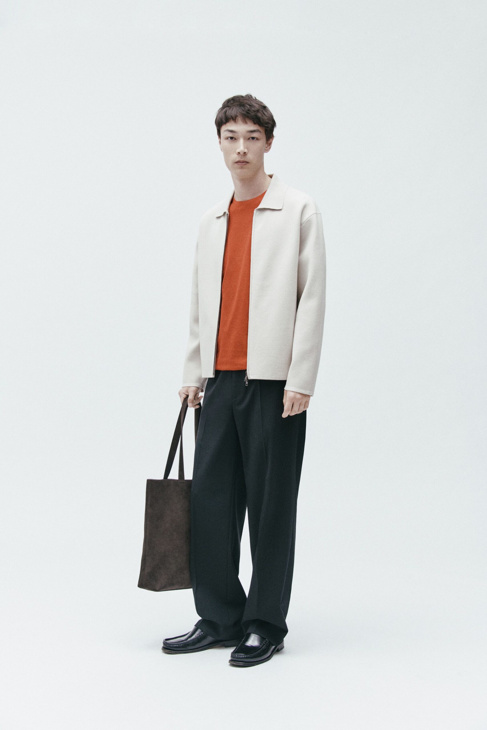 white jacket orange t-shirt black pants
