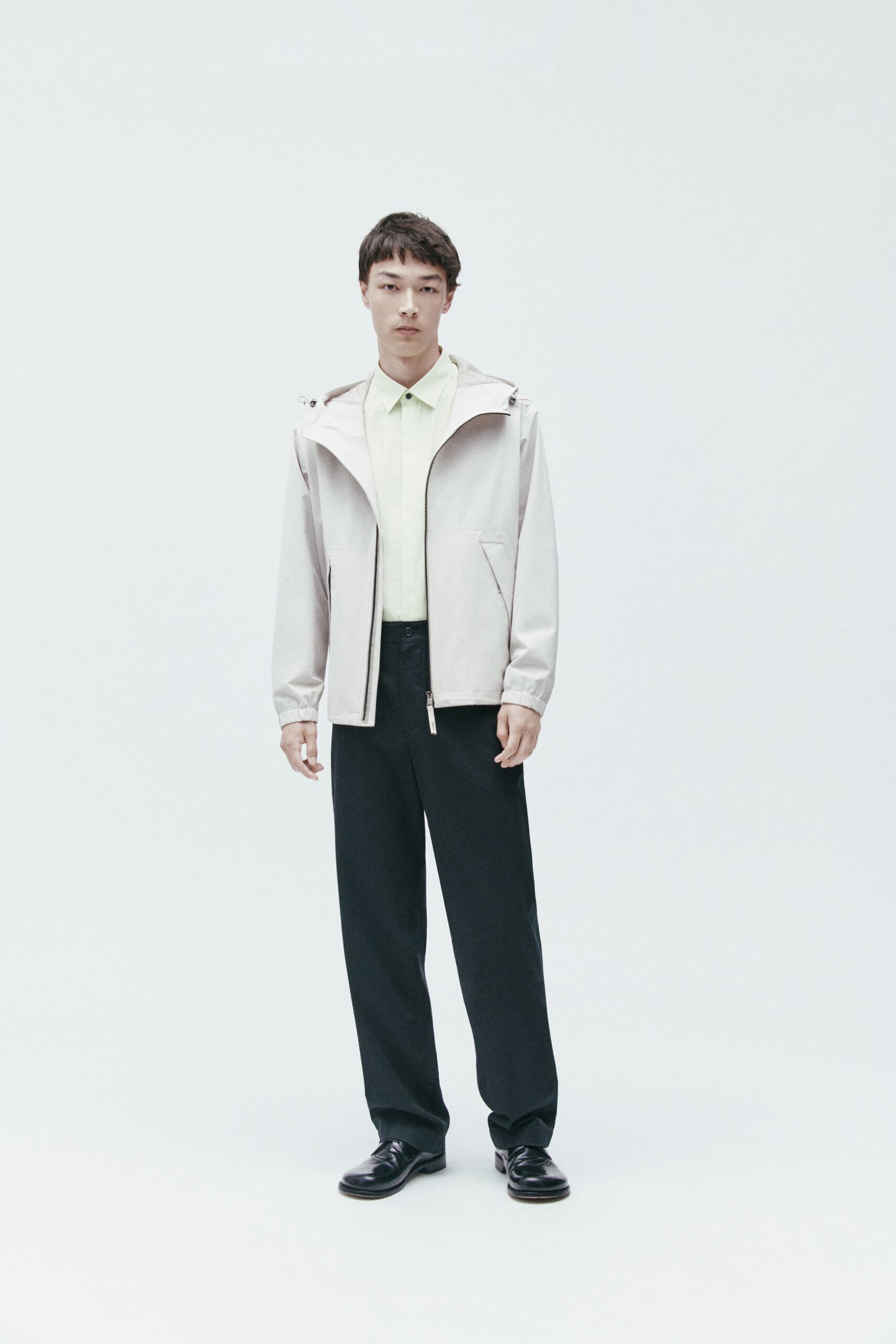 white jacket light green shirt black pants